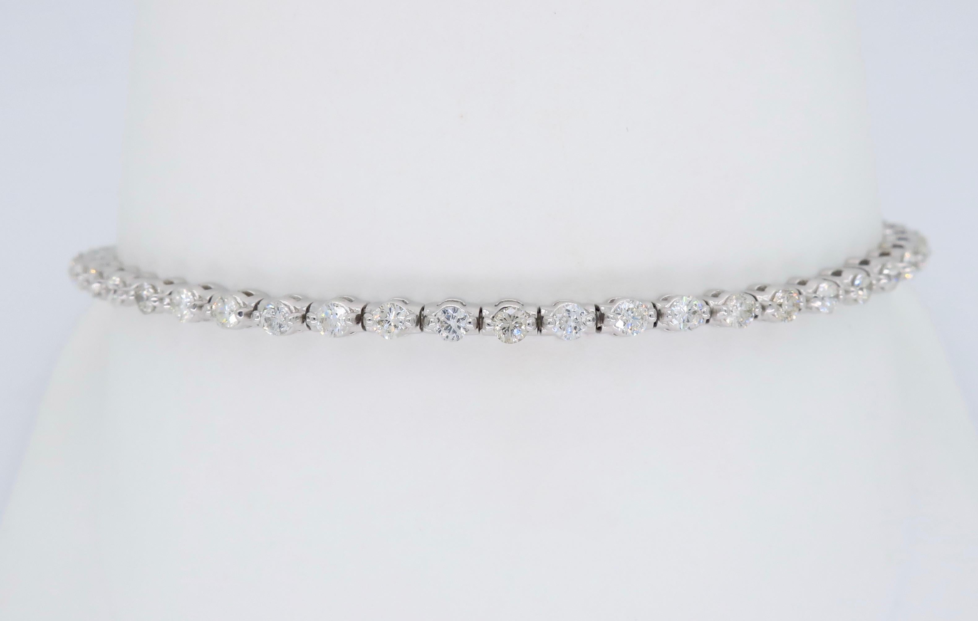 This stunning tennis bracelet features 51 elegantly prong set Round Brilliant Cut Diamonds.

Diamond Carat Weight: 2.00CTW
Diamond Cut: 51 Round Brilliant Cut Diamonds
Color: Average G-J
Clarity: Average SI-I
Metal: 14K White Gold
Marked/Tested: