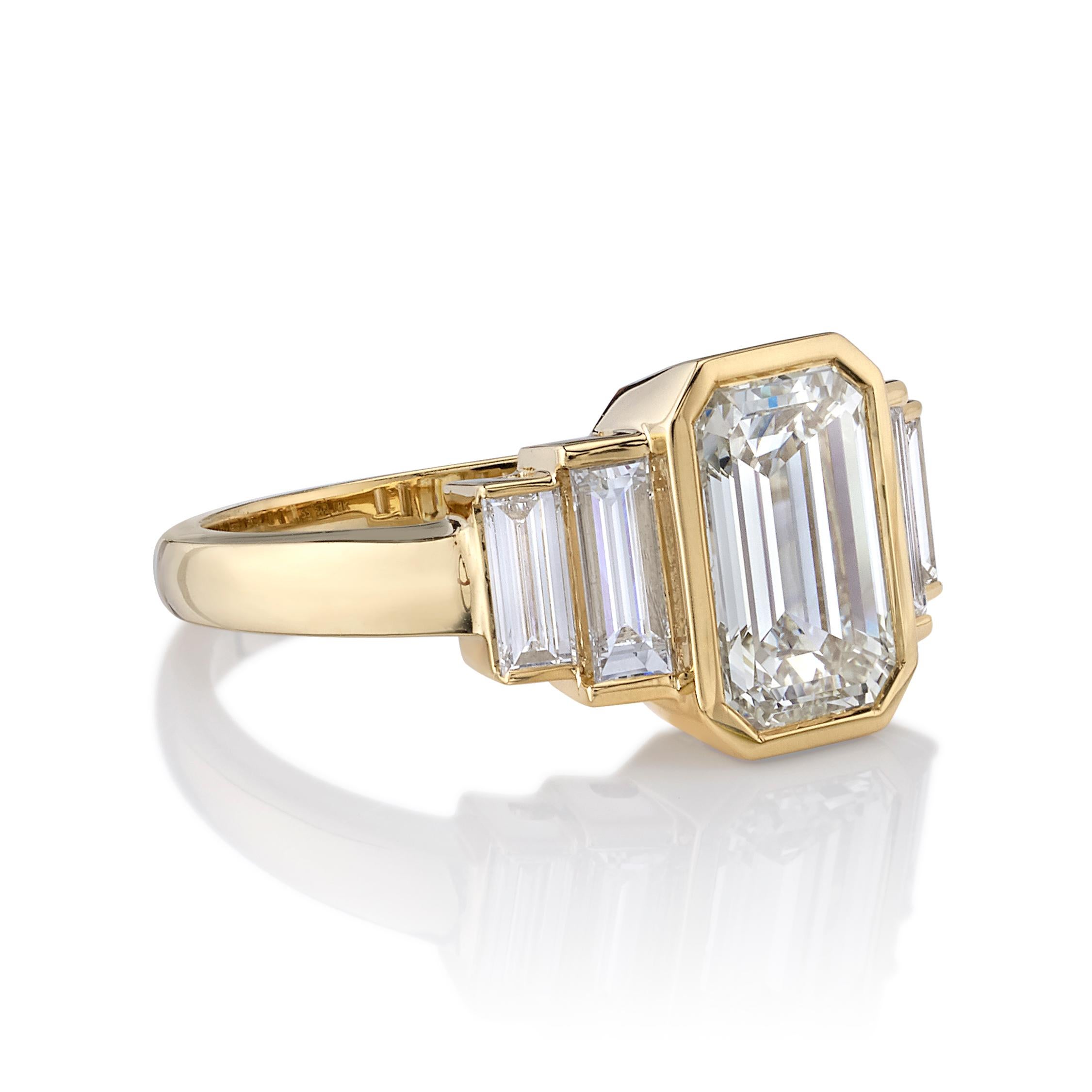 2.00ctw O-P/VS1 GIA certified Emerald cut diamond with 0.49ctw Baguette cut accent diamonds set in a handcrafted 18K yellow gold mounting.

Ring is a size 6 and can be sized to fit.