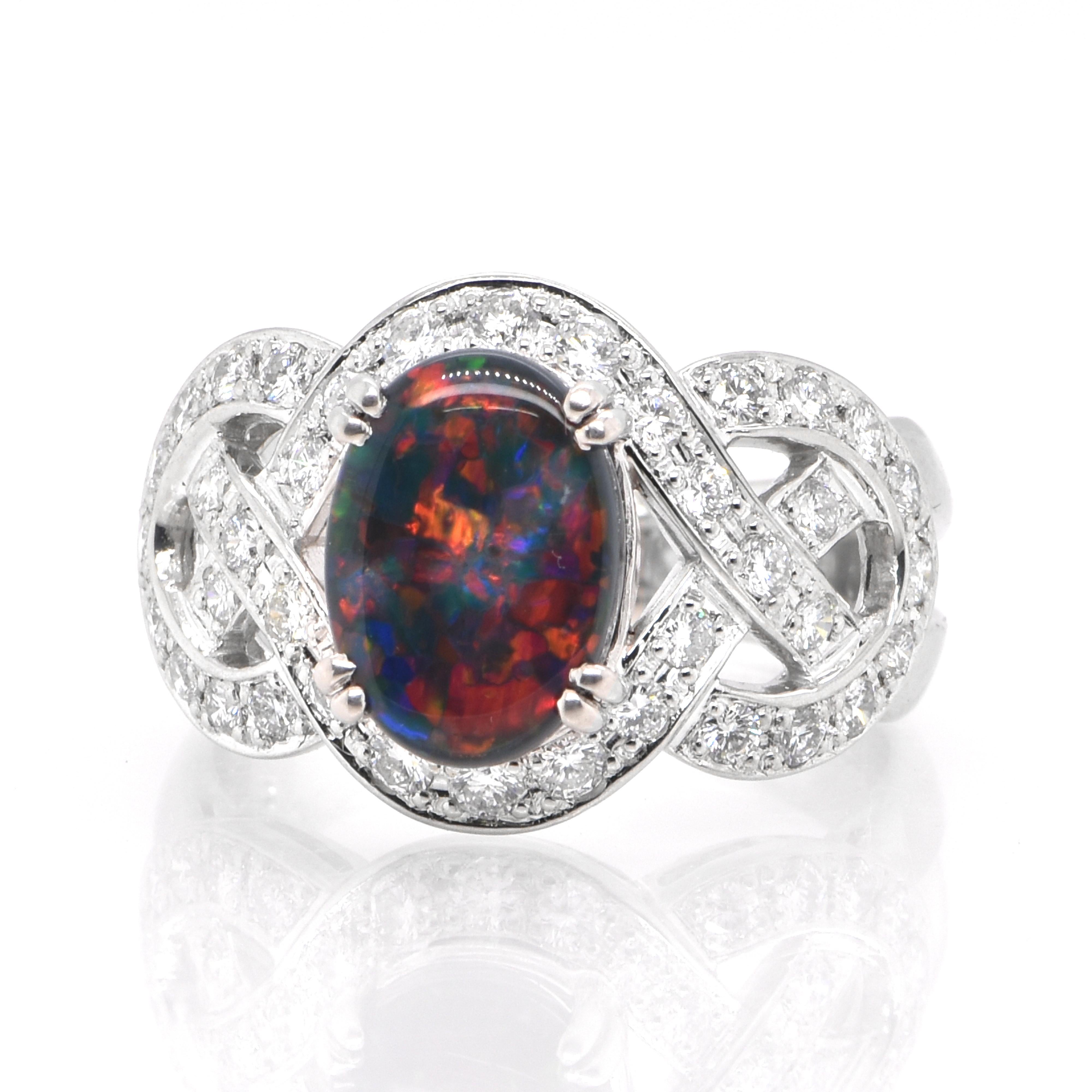 A beautiful ring featuring a 2.00 Carat, Natural, Australian (Lighting Ridge) Black Opal and 0.67 Carats of Diamond Accents set in Platinum. The Opal displays very good play of color! Opals are known for exhibiting flashes of rainbow colors known as