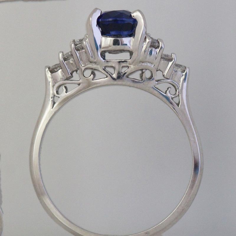 2.00+ Carat Royal Blue Sapphire, set in platinum. 12 Side Round Diamonds weighing a total of 0.45 Carats with G-H Color, VS - SI Clarity.

1. Carat Weight: 2.00 + Carat Sapphire

2. Color: Intense Royal Blue

3. Tone:  Medium - 7.5 Out of 10, any