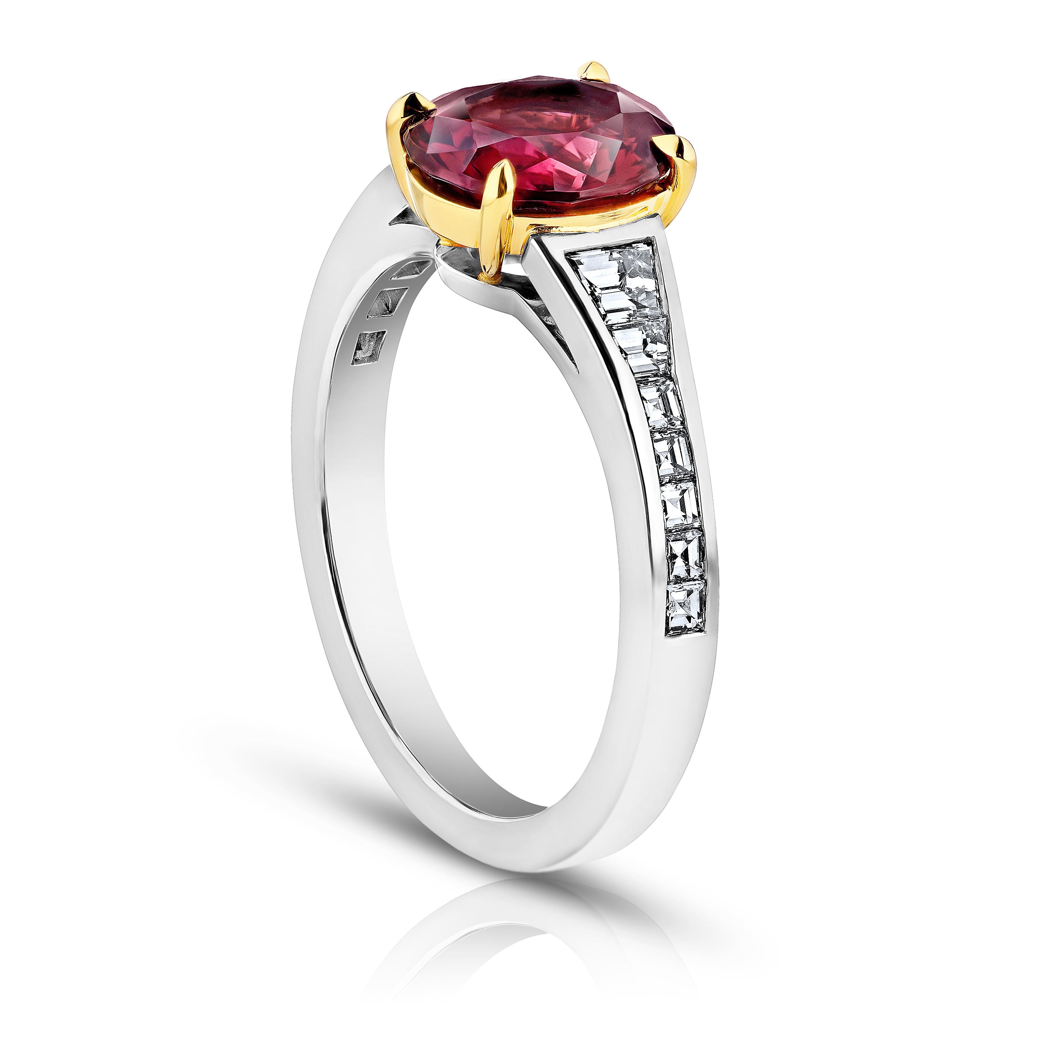 2.00 carat oval red spinel with 14 trapezoid and carre diamonds .58 carats channel set in a platinum with 18k yellow gold ring. This ring is currently a size 7.  We will resize to your finger size without charge.
