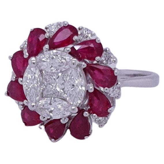 A brand new ruby and diamond ring in 18K gold. By creating an illusion of diamond in the center so it seems to be one piece, and ruby pears weighing 2.00 carats are positioned around it. It has 1.35 carats of diamonds in various shapes. This ring