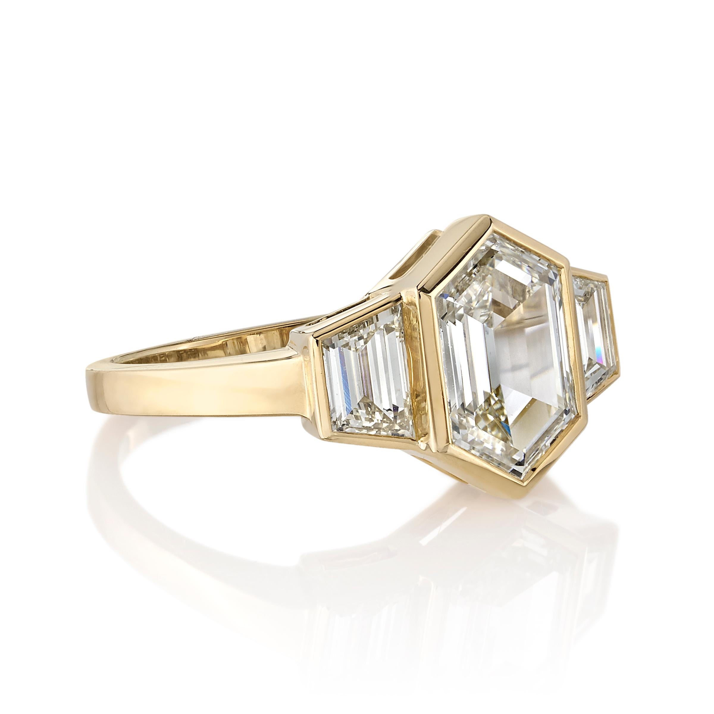 2.00ctw M/VVS2 GIA certified hexagonal Step cut diamond set in a handcrafted 18K yellow gold mounting. 0.77ctw Trapezoid cut accent diamonds flank the center stone. 

Ring is a size 6 and can be sized to fit.