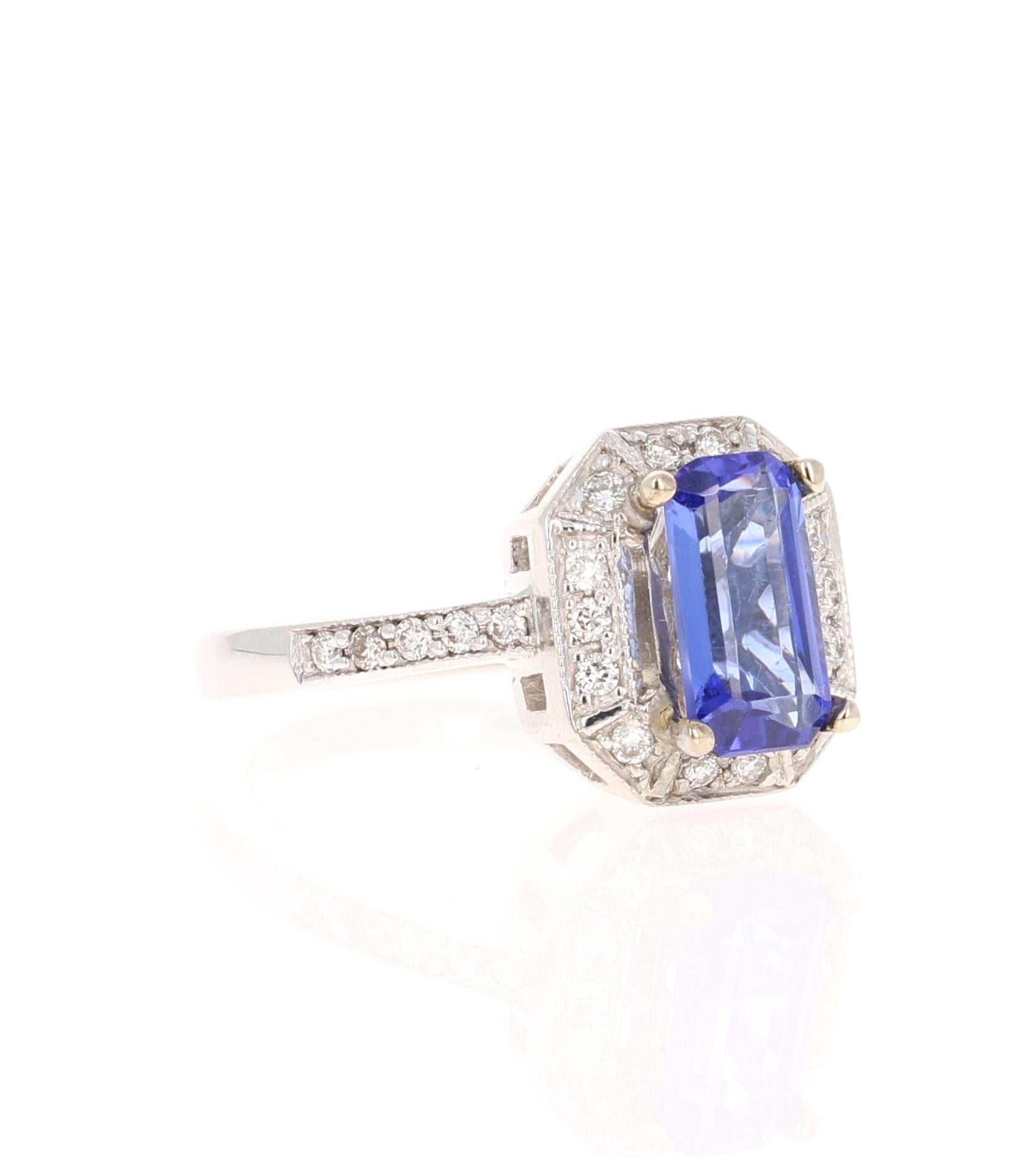 Questo bellissimo anello ha una vivida tanzanite taglio smeraldo da 1,66 carati. La tanzanite è circondata da 26 diamanti taglio rotondo del peso di 0,34 carati. (Chiarezza: SI, Colore: F)  Il peso totale dell'anello è di 2,00 carati.  

La
