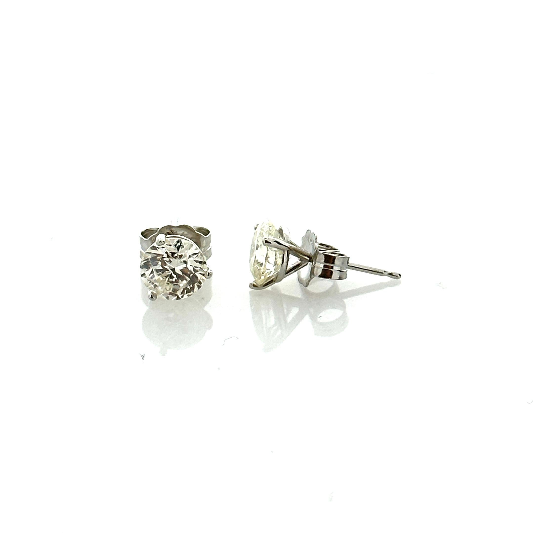 Stunning 14 Karat white gold handmade earrings featuring 2 round brilliant cut diamonds weighing 2.00 carat total I-J color and SI1 clarity. These gorgeous earrings are classic and timelessly elegant.