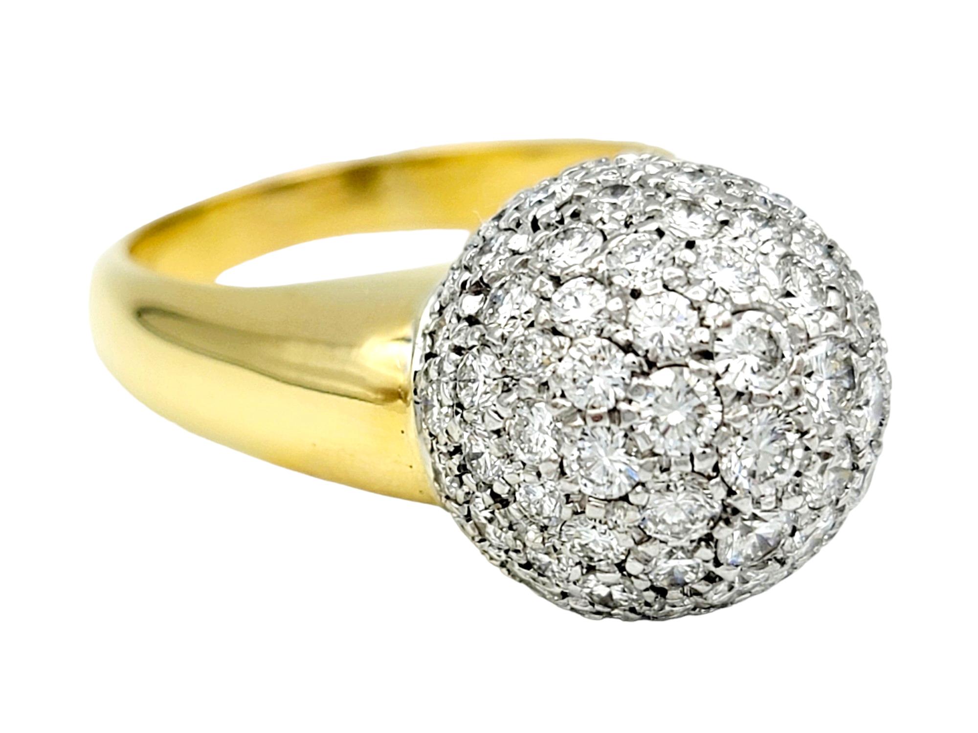 Ring Size: 8.75

Indulge in the luxurious allure of this 18 karat yellow gold band ring, designed to make a statement with every glance. At its apex sits a mesmerizing clustered diamond dome, boasting a remarkable 2.00 carats of diamonds, F-G in