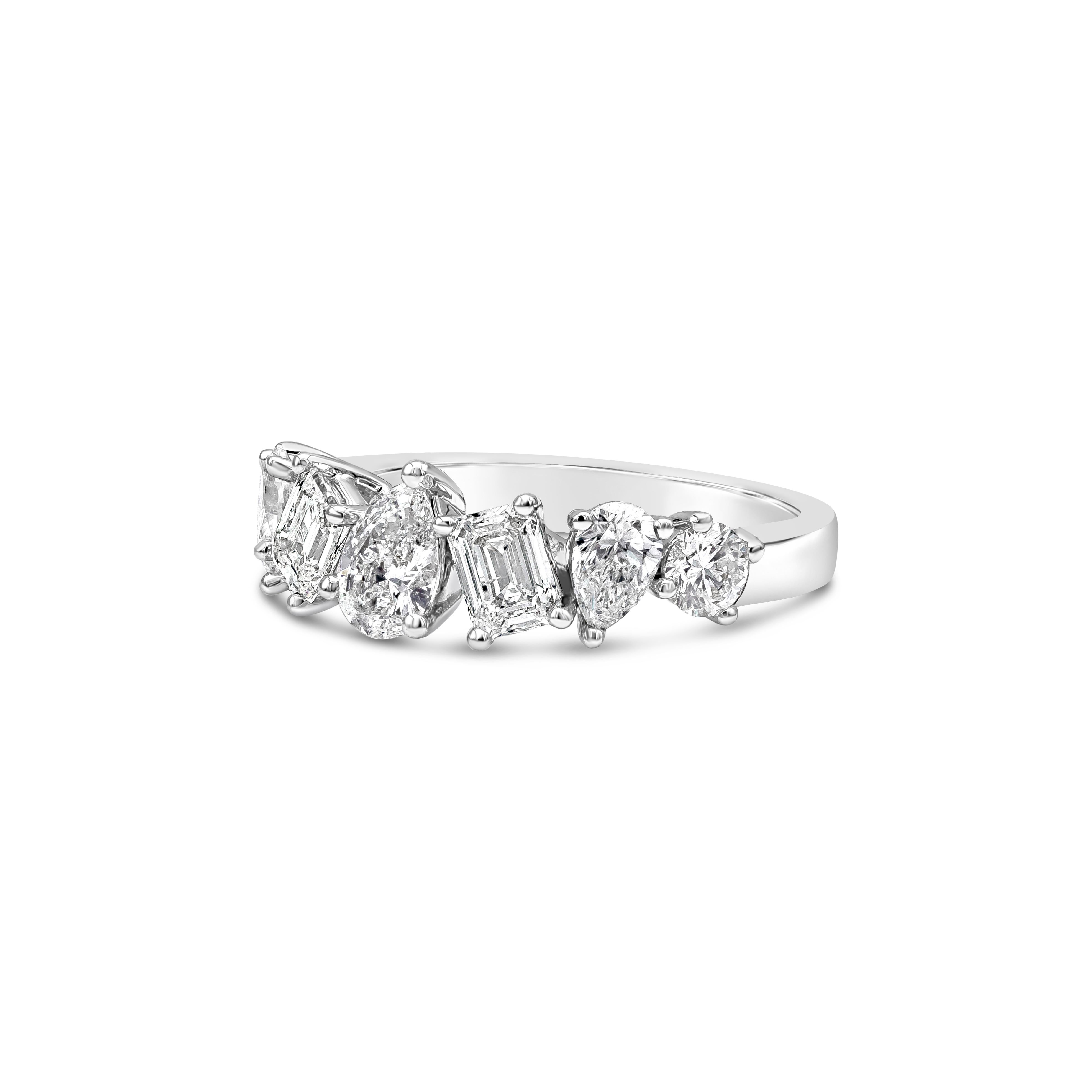 A sophisticated but modern piece of jewelry showcasing an alternating seven mixed cut diamonds that includes brilliant round, emerald cut and pear shape, elegantly set half way that is made in 18 karat white gold. The weight of the diamonds is 2.00