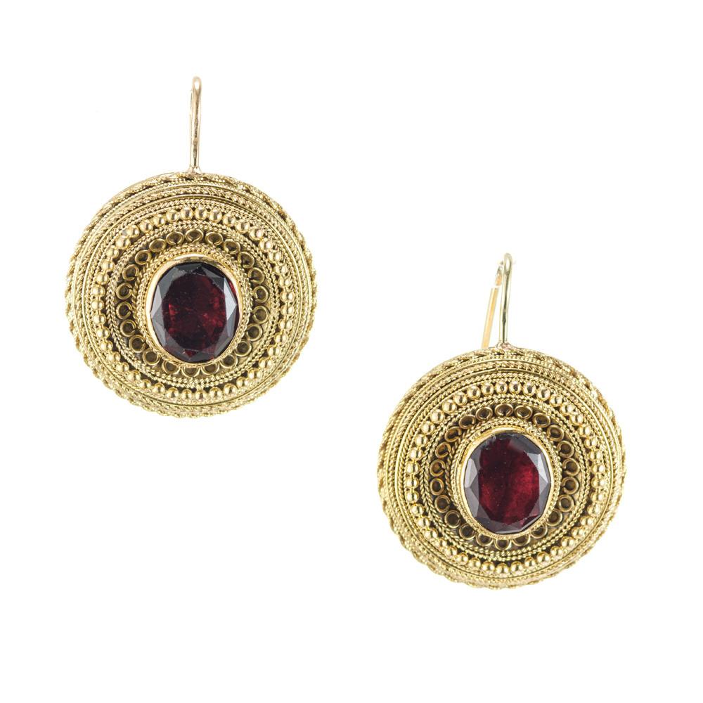 Handmade round antique Georgian earrings with earwires circa 1800's. 

2 oval brownish red garnets, approx. 2.00cts
14k yellow gold
Tested: 14k
6.6 grams
Top to bottom: 24.7mm or .97 Inches 
Width: 18.8mm or .74 Inches
Depth or thickness: 6.5mm
