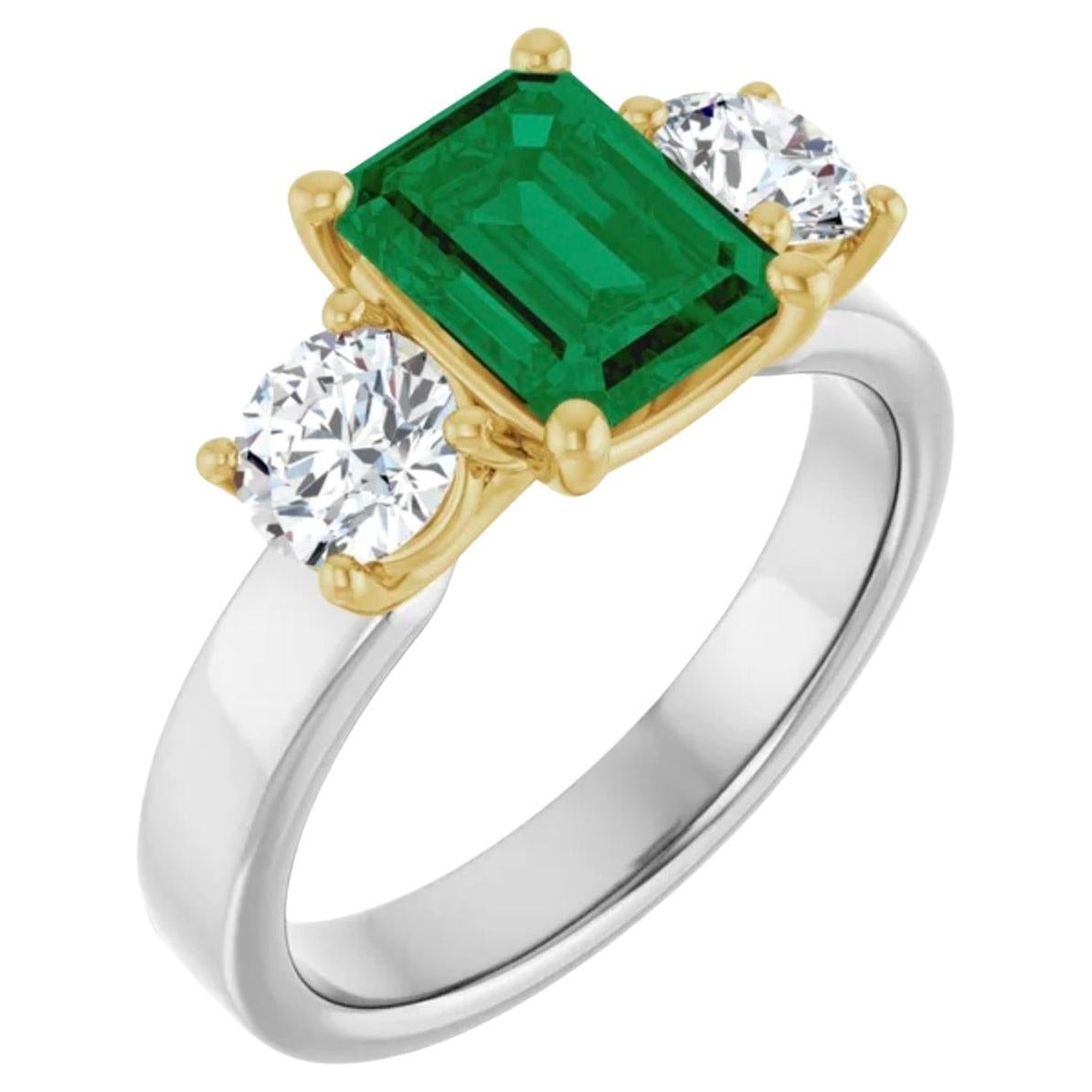 18K White/Yellow Ring  set wit a center Natural AAA Colombian Emerald Engagement Ring. The emerald is bright best green AAA clarity and color 7.6mm x 5.7mm aprox. 1.10 carats. 
Diamonds each 4.8mm Full Cut,  G-H color,  SI1 clarity 0.45ct 
\Total 2