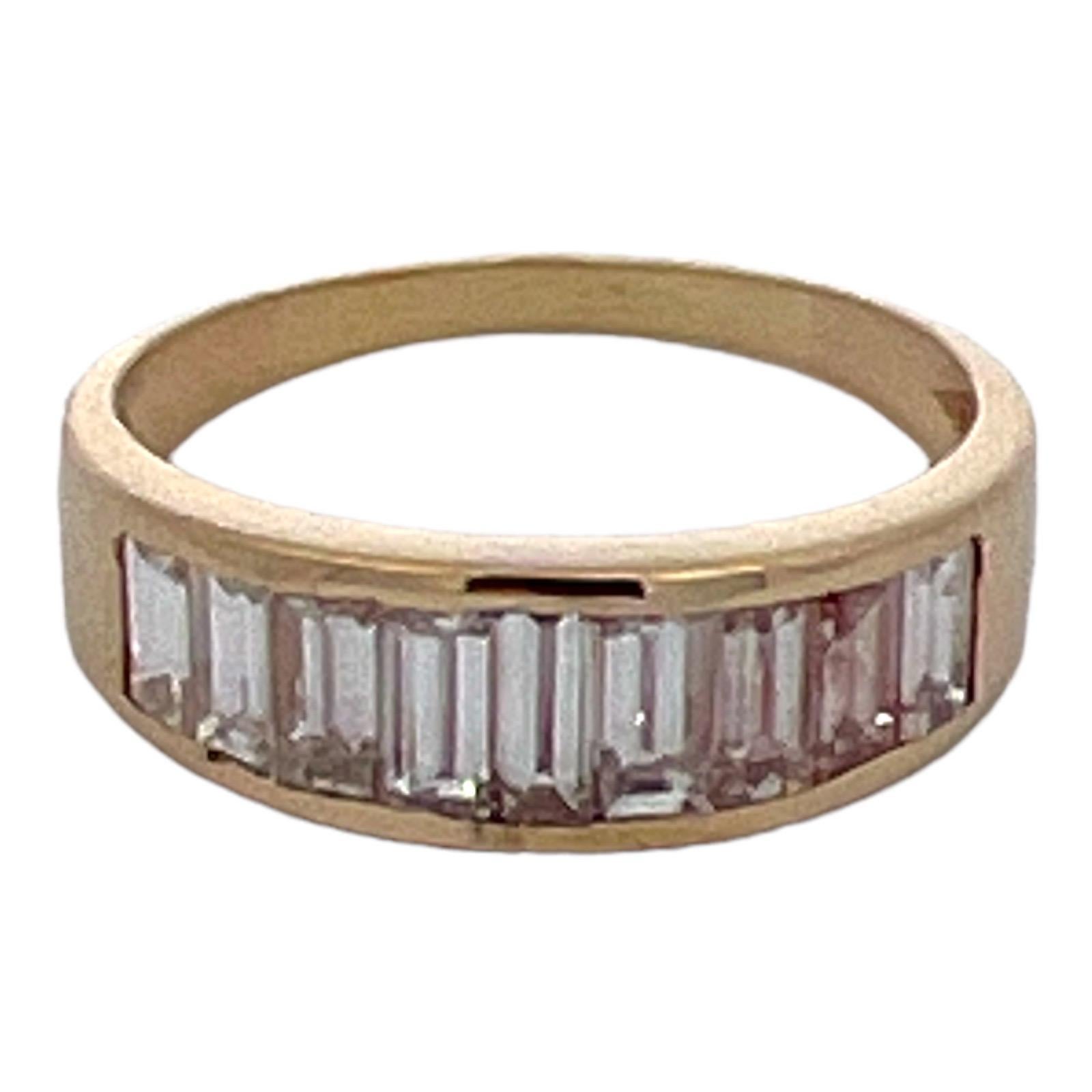 Baguette diamond channel set wedding band crafted in 14 karat yellow gold. The band features 9 baguette diamonds weighing approximately 2.00 carat total weight and graded I color and VS clarity. The graduated band measures 2.0 -6.5mm in width, and