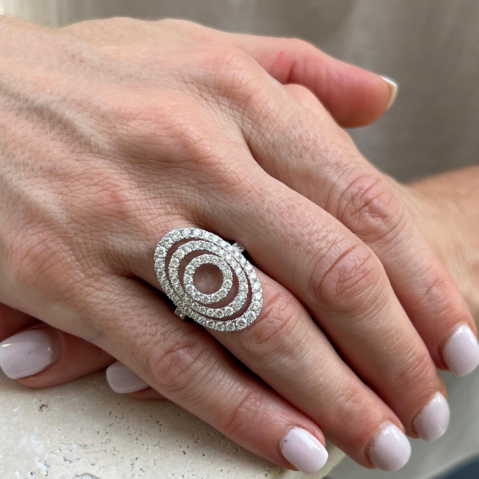 Modern diamond cocktail ring crafted in 18 karat white gold. The open circle ring features round brilliant cut diamonds weighing 2.00 carat total weight and graded G-H color and SI clarity. The ring is currently size 7 (can be sized), and measures