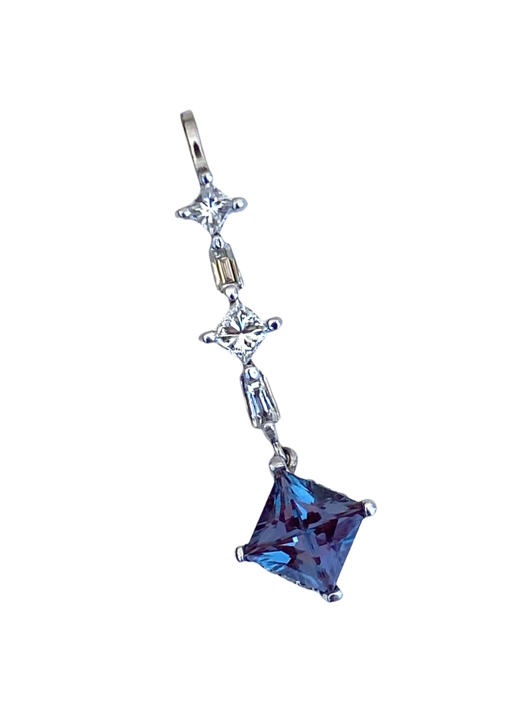 Princess cut mystic topaz measures 6.50 mm in diameter and weighs approximately 1.50 carat. The pendant is dazzled with diamond cuts of baguettes and round also on the underneath side of the setting.

Diamonds have a total weight of .60 carat. 