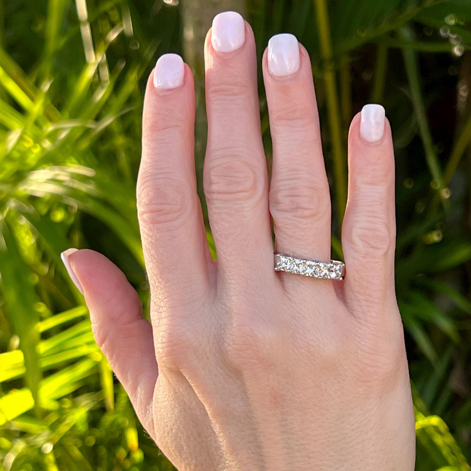 Princess cut diamond shared prong wedding band handcrafted in platinum. The 5 princess cut diamonds weigh approximately 2.00 carat total weight and are graded G-H color and VS clarity. The band measures 5.5mm in width, and is currently size 11 (can