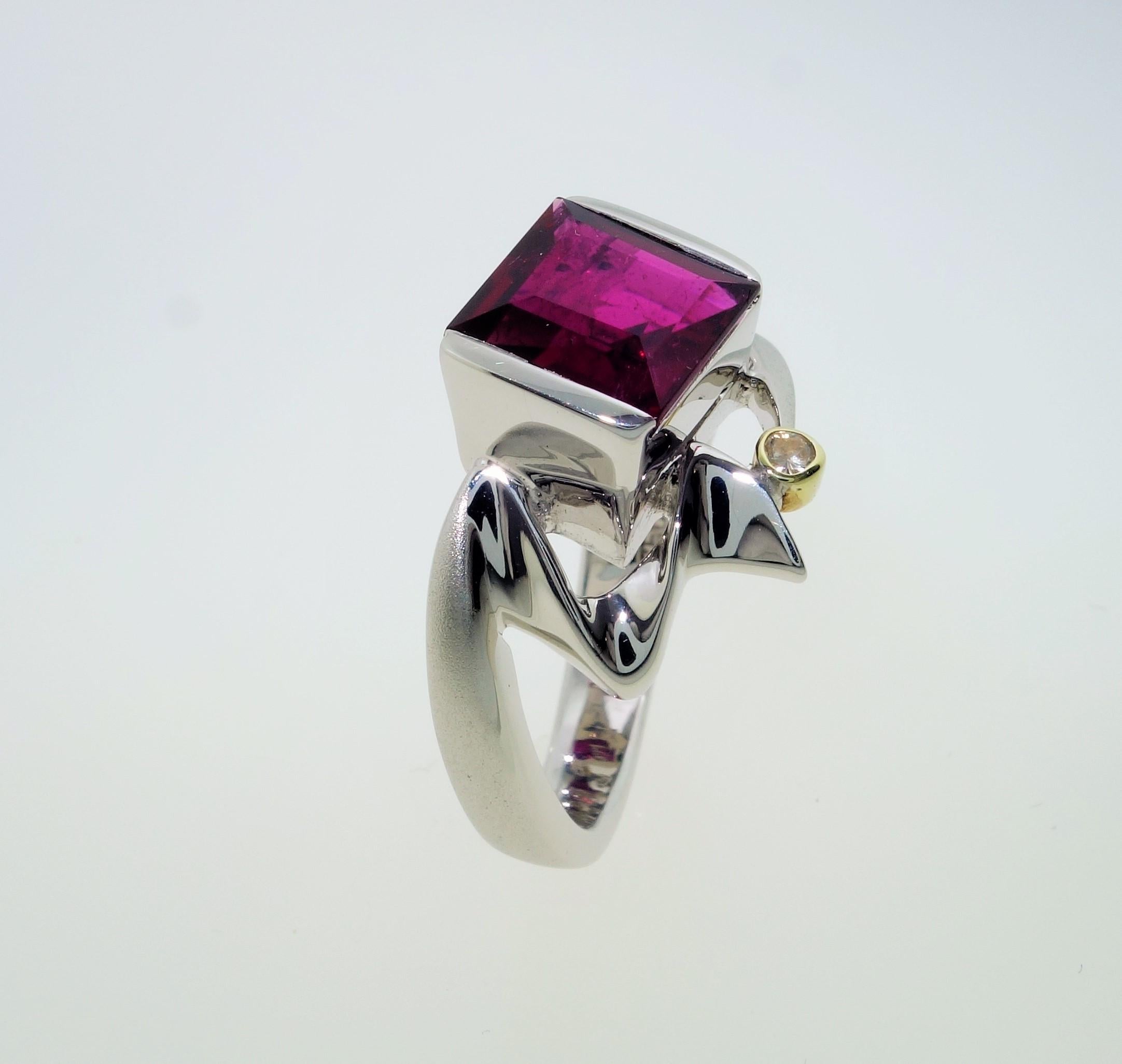 Simply Beautiful, Elegant and finely detailed Cocktail Ring, center securely set with a 2.00 Carat Rubellite Tourmaline, measuring 7.5mm x 7 mm and accented by 2 Diamonds. Hand crafted in Rhodum sterling silver and 18  Karat yellow Gold. The ring