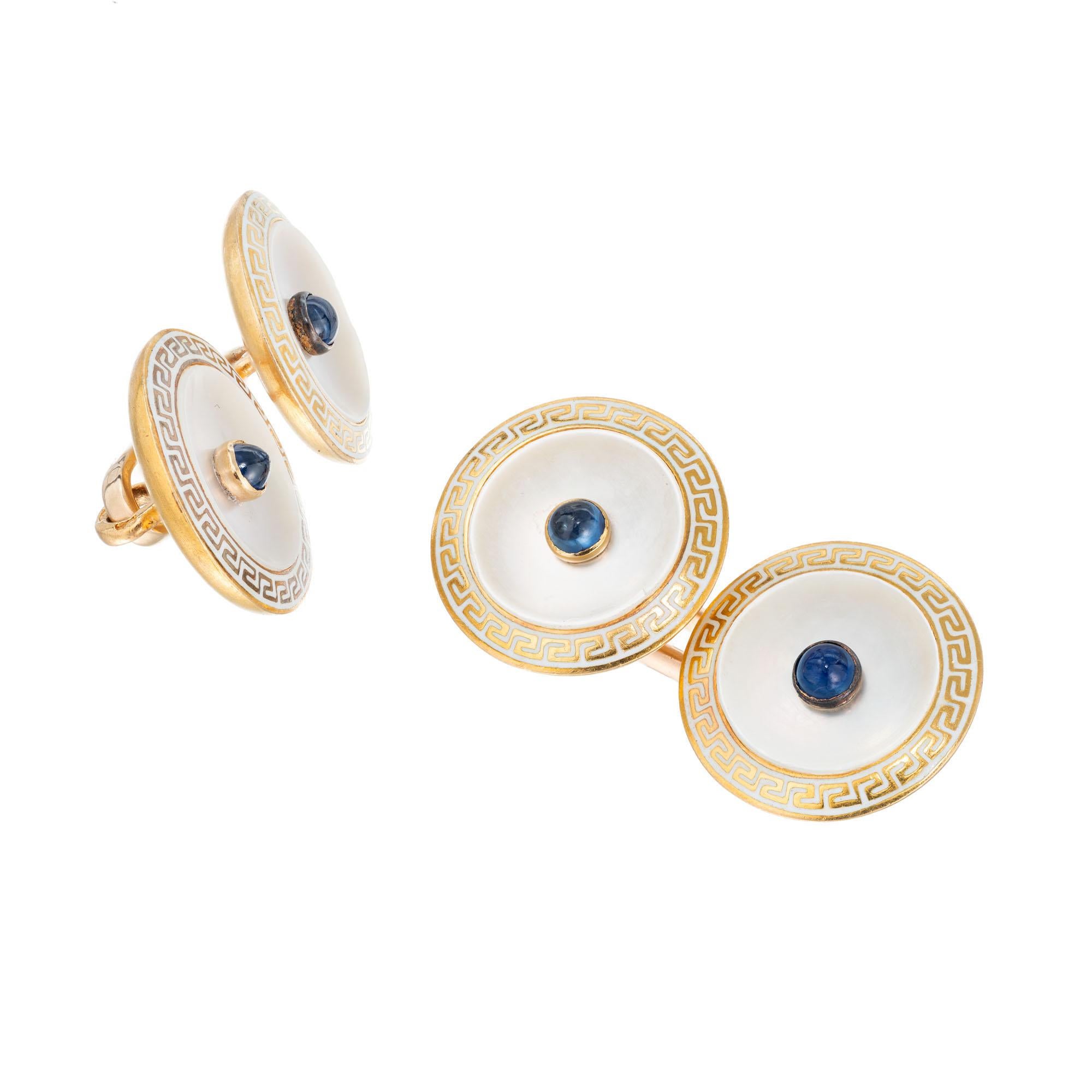 Early 1900's double sided cufflinks in 14k yellow gold with mother of pearl, cabochon sapphire and white enamel Greek key border.

4 round cabochon blue sapphires, approx. .20cts
4 discs of white mother of pearl 
14k yellow gold 
Tested: 14k
8.8