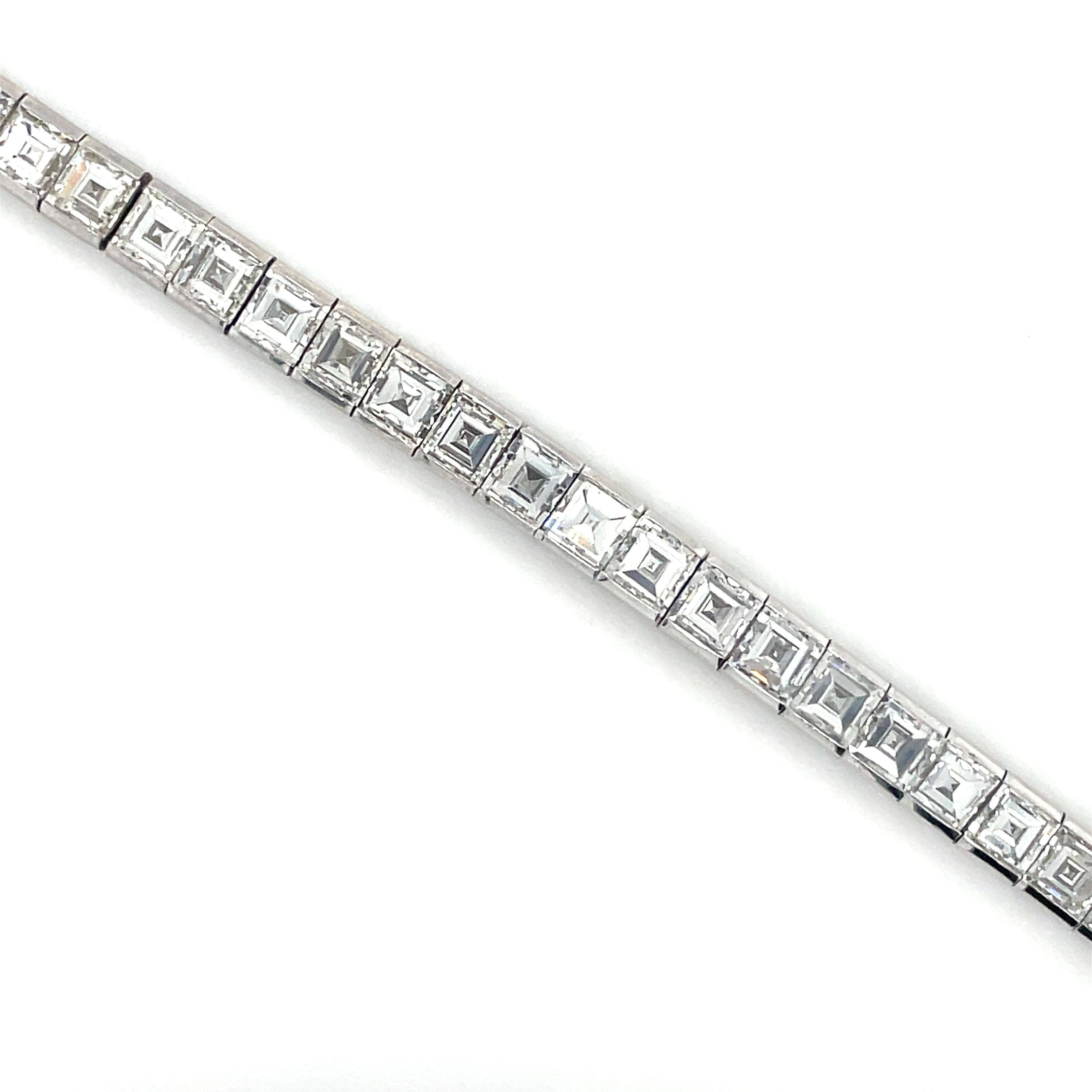 This show stopping bracelet contains 43 top quality carré cut diamonds weighing approximately 20.00 carats total. Beautifully crafted in platinum, this bracelet is a must for any collector.

Measurements: 7 1/4 inches long.
Metal: Platinum.
Gross