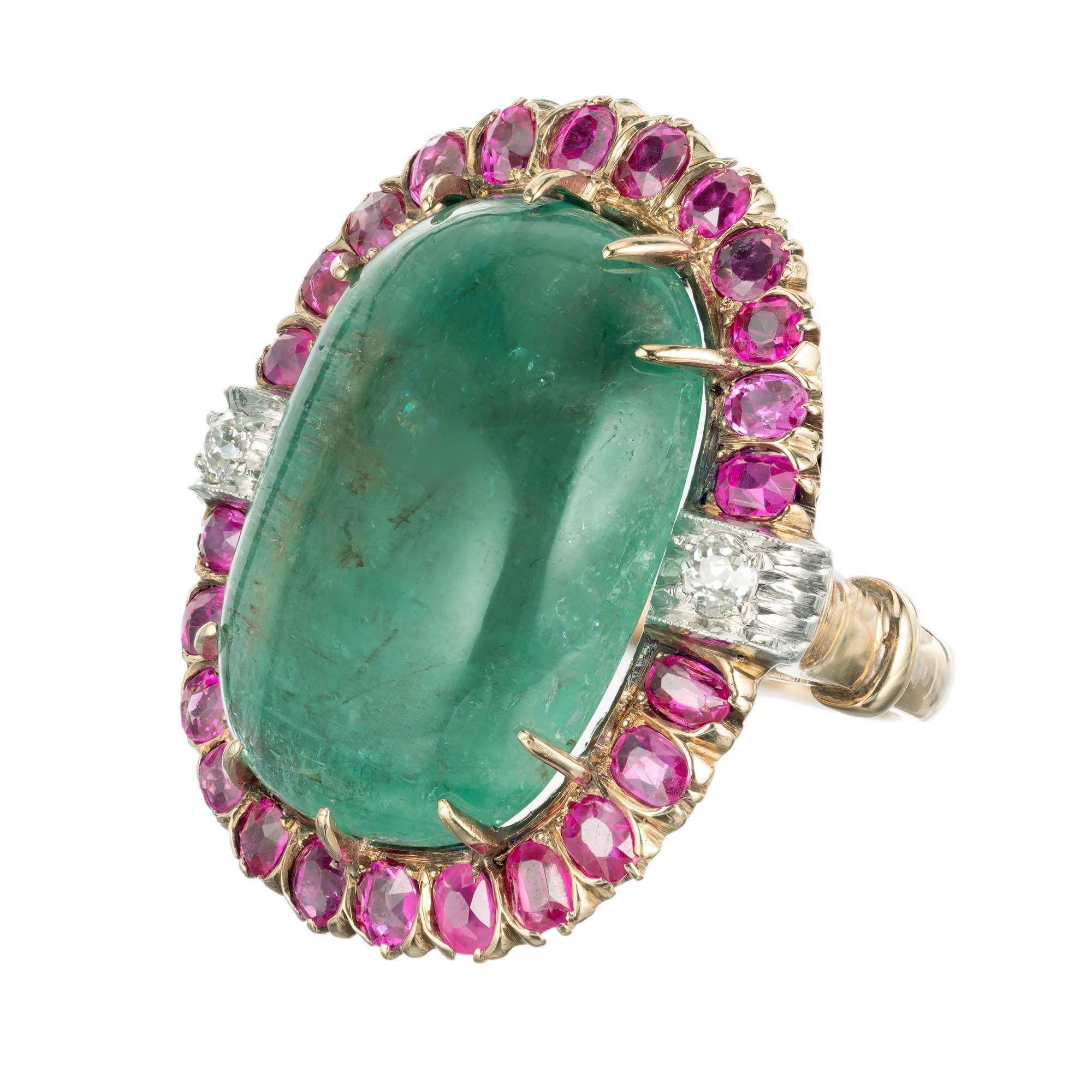 Absolutely stunning 1930's oval cabochon emerald, sapphire and diamond cocktail ring. A Staggering 20.00ct oval emerald surrounded by a halo of natural no heat pink Sapphires with two accent side diamonds in a 14k yellow gold platinum setting. AGL