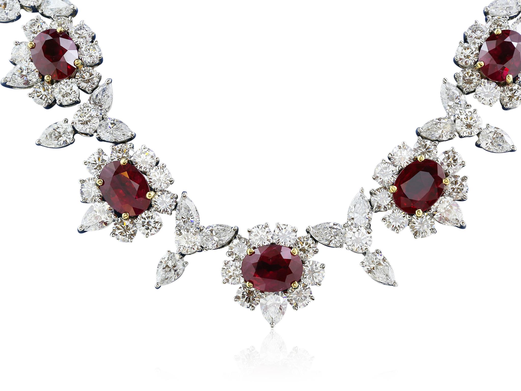 Platinum Ruby and Diamond Necklace consisting of 9 oval shaped Burma Rubies weighing 20.00 carats set with pear shaped and round brilliant cut diamond weighing approximately 42.00 carats with a color and clarity of G VS2 respectively.