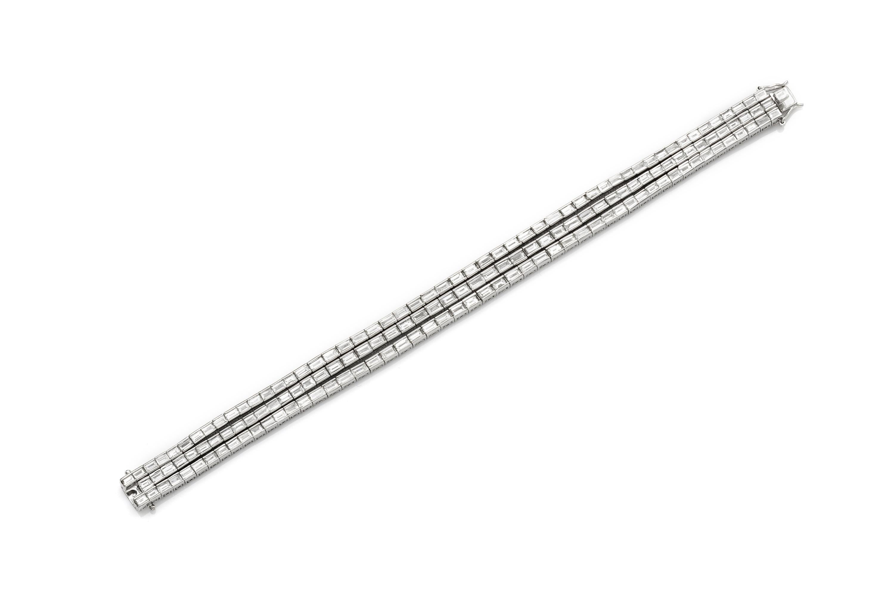 Finement réalisée en platine avec trois rangées de diamants baguette en serti clos pesant approximativement un total de 20,00 carats, couleur F-G, pureté VS1-VS2.
Taille 7 pouces