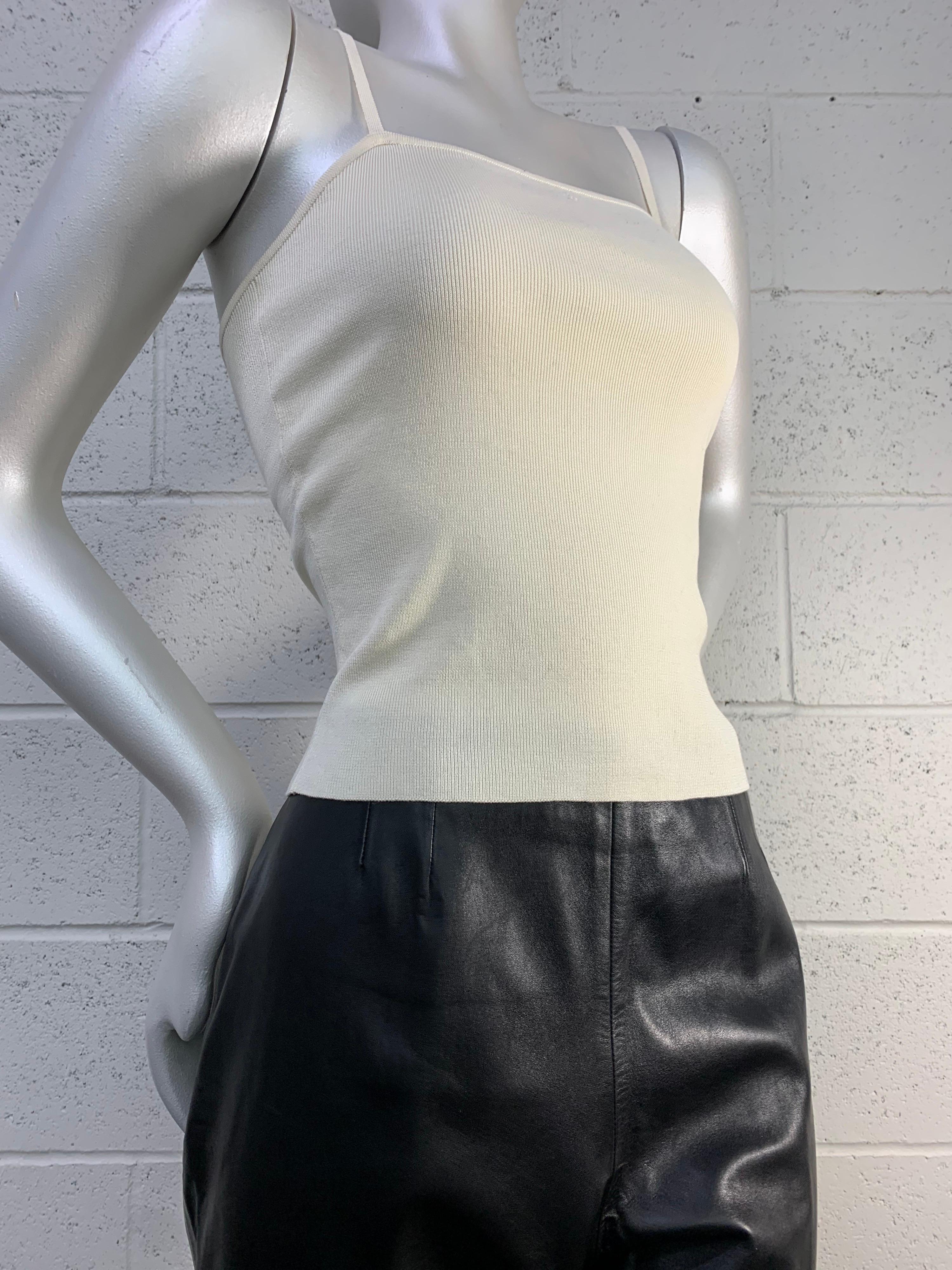2000 Chanel Autumn black lambskin flat-front wide-leg pant with no waistband or belt loops. Side zipper. Size EU44. 

2000 Chanel Cruise cream rib-knit camisole with lingerie straps and back zipper make this a classic minimalist look. Size EU42