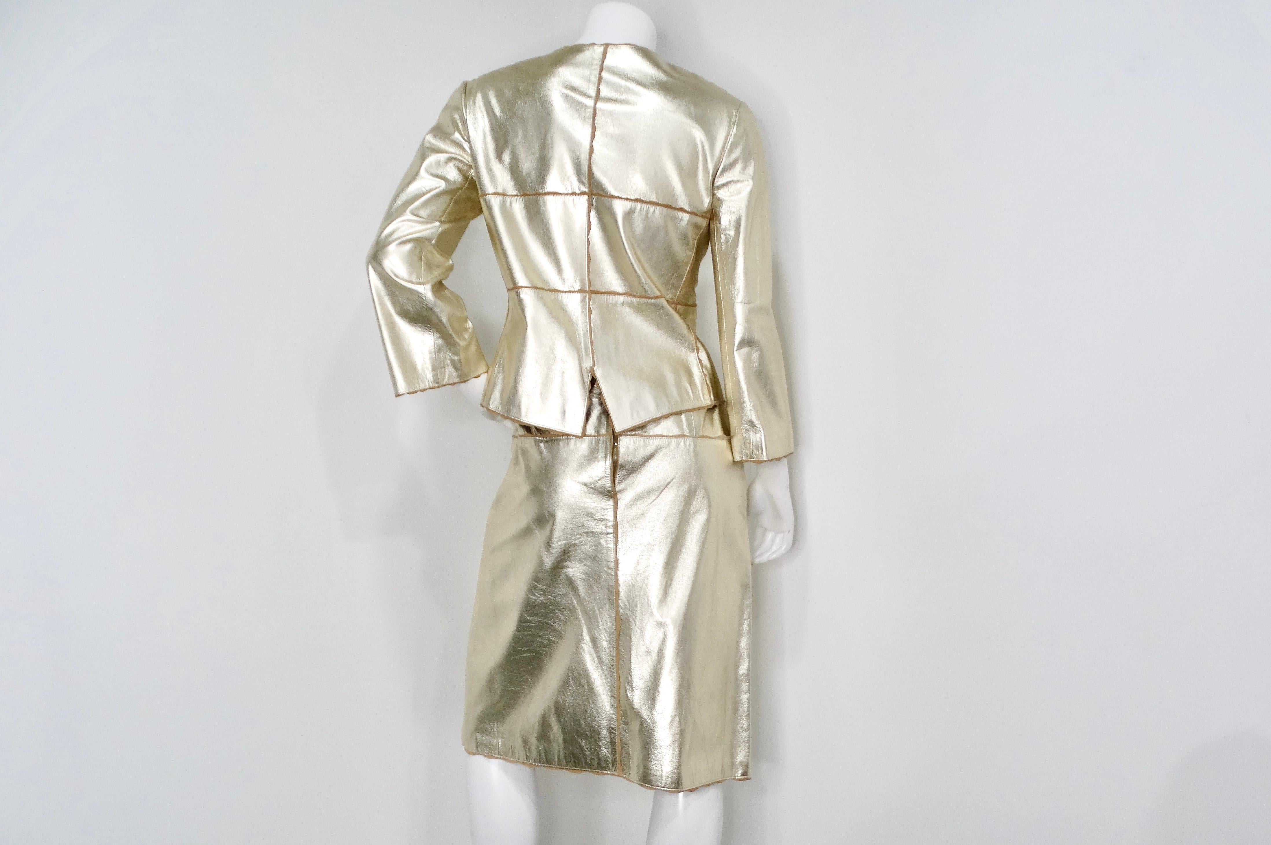 The 2000 Chanel Gold Metallic Suede Goatskin Jacket and Skirt Set is a stunning example of high fashion, exuding elegance and sophistication. This exquisite ensemble features a luxurious gold metallic finish, perfect for making a statement at any