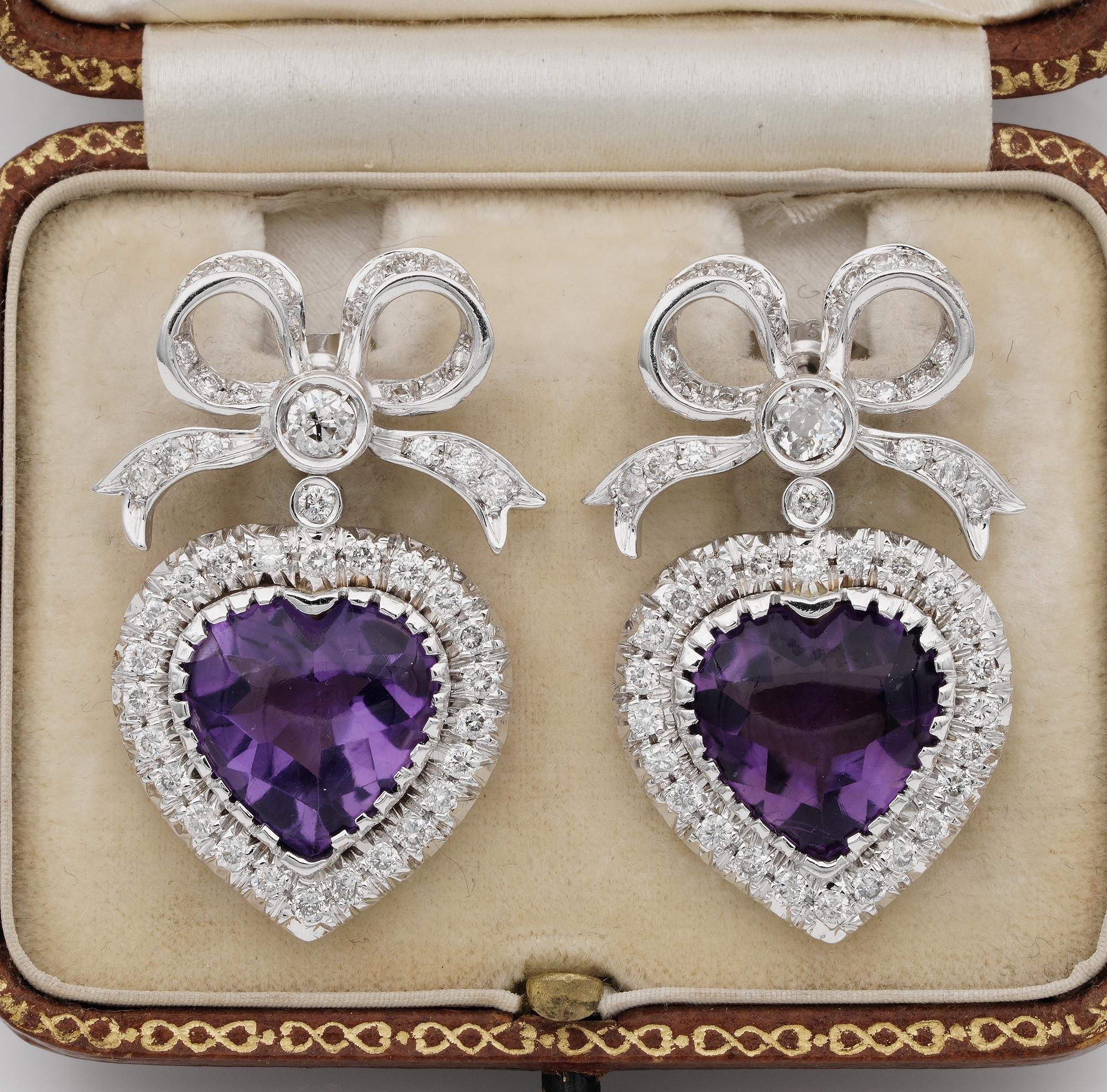 This fine pair of Diamond &  Amethyst earrings are 1960 ca.
Individually hand fabricated as unique of solid 18 KT white gold
Inspired by the Victorian sweet heart jewellery gorgeously modelled with a top bow and a sweet heart swinging down
They give