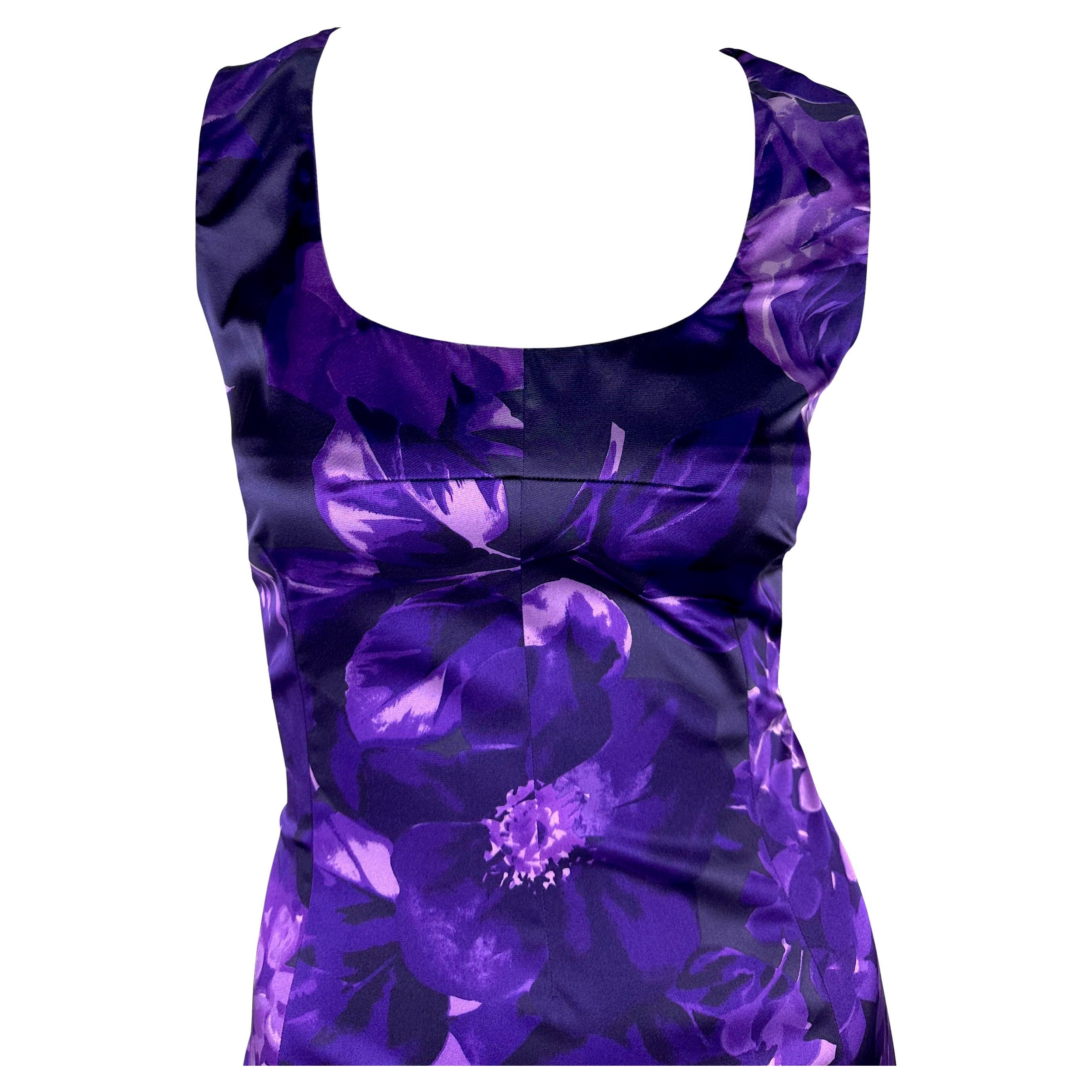 Dieses knielange Kleid von Dolce & Gabbana ist mit einem farbenfrohen Blumenmuster in Lila-Tönen versehen, das den Körper schön umspielt. Mit seinem Rundhalsausschnitt und den breiten Schulterträgern setzt dieses seidige Kleid ein gewagtes Statement