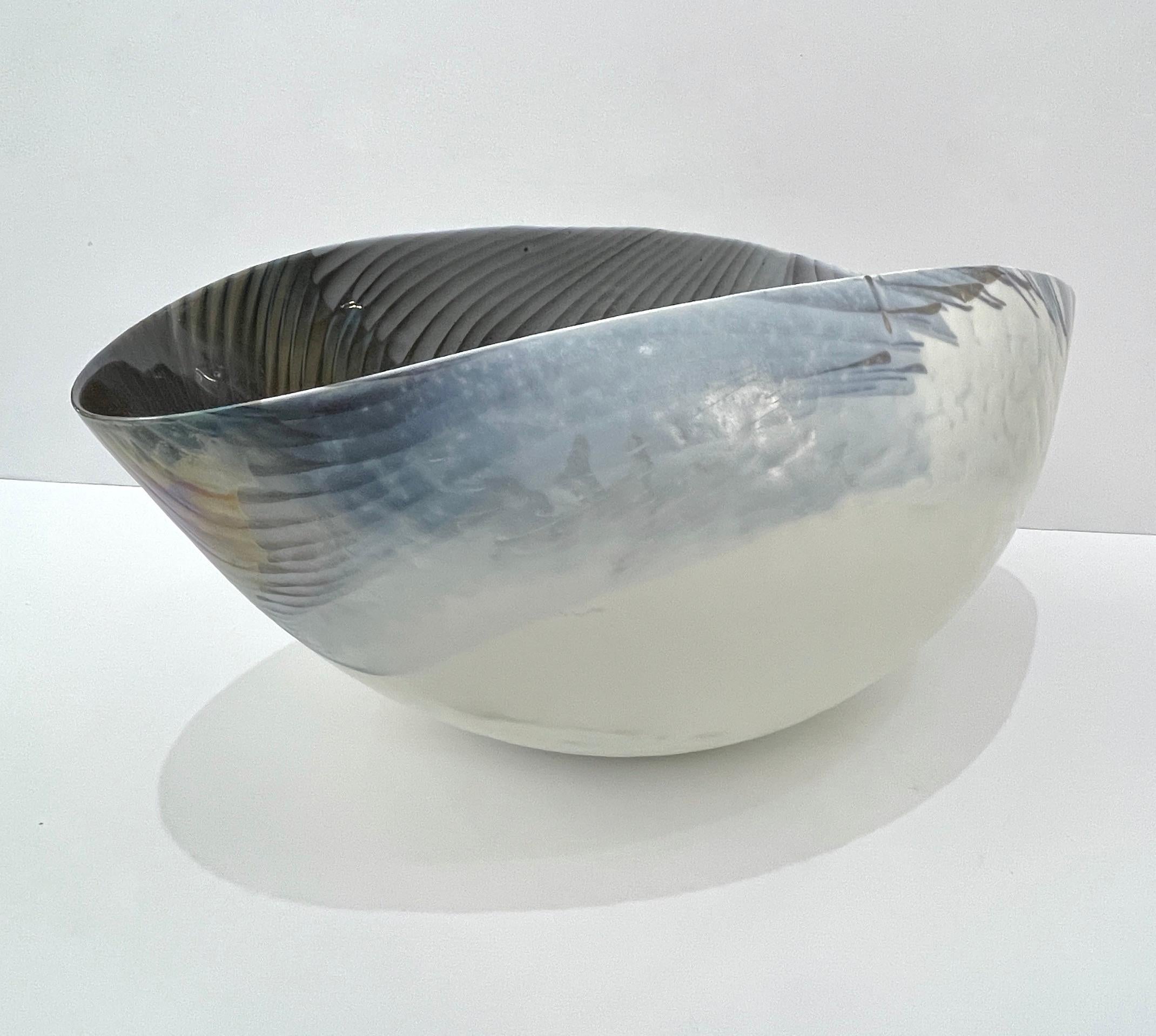 Exclusive very elegant Italian bowl, huge Venetian blown Murano glass modern centerpiece, with an unusual organic shape and a waved rim. The iridescent azure blue and ivory white Murano glass is decorated with a sophisticated blown bird feather