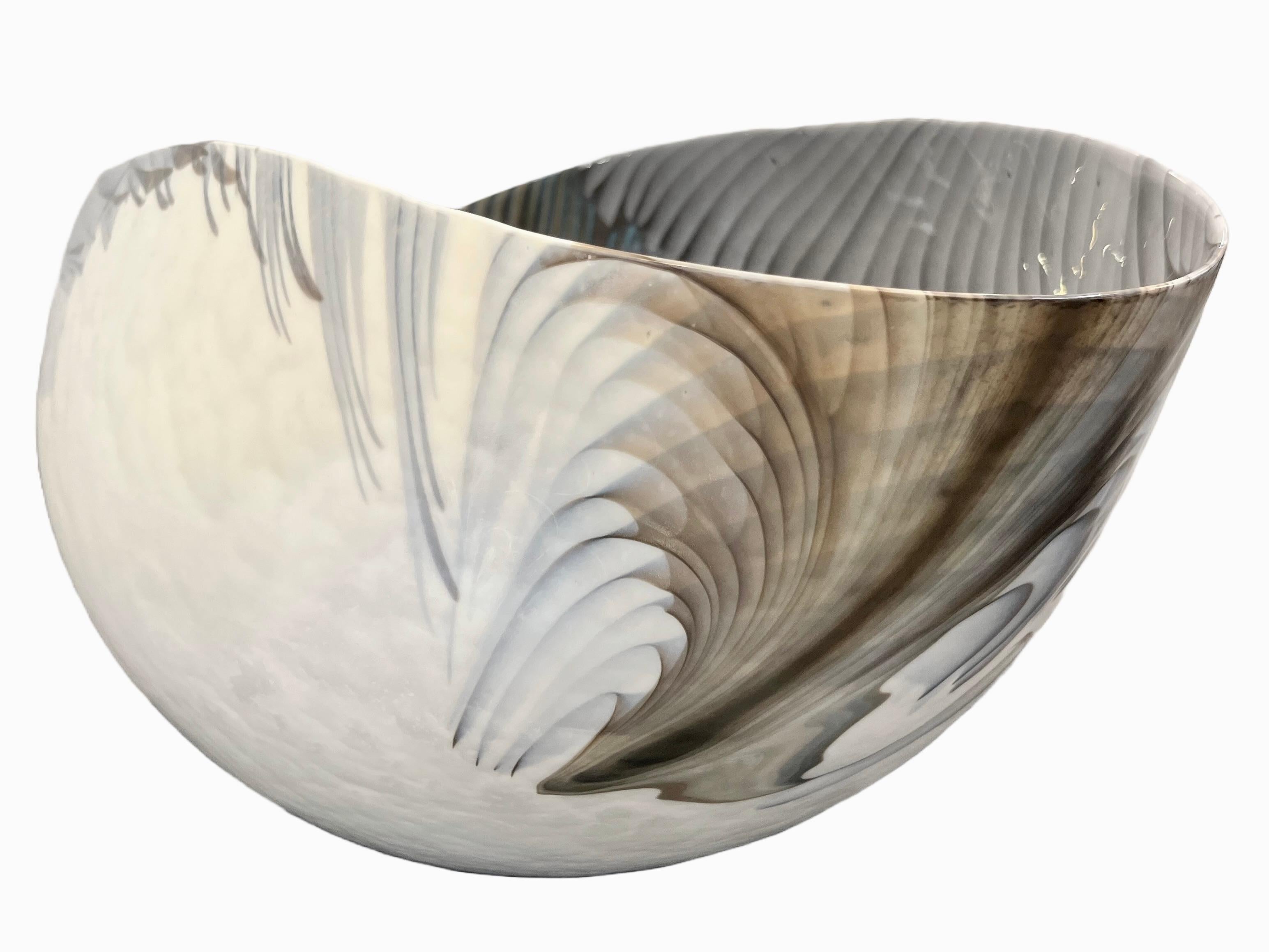 Exclusive very elegant Italian bowl, huge Venetian blown Murano glass modern centerpiece, with an unusual organic shape and a waved rim. The iridescent azure blue and ivory white Murano glass is decorated with a sophisticated blown bird feather