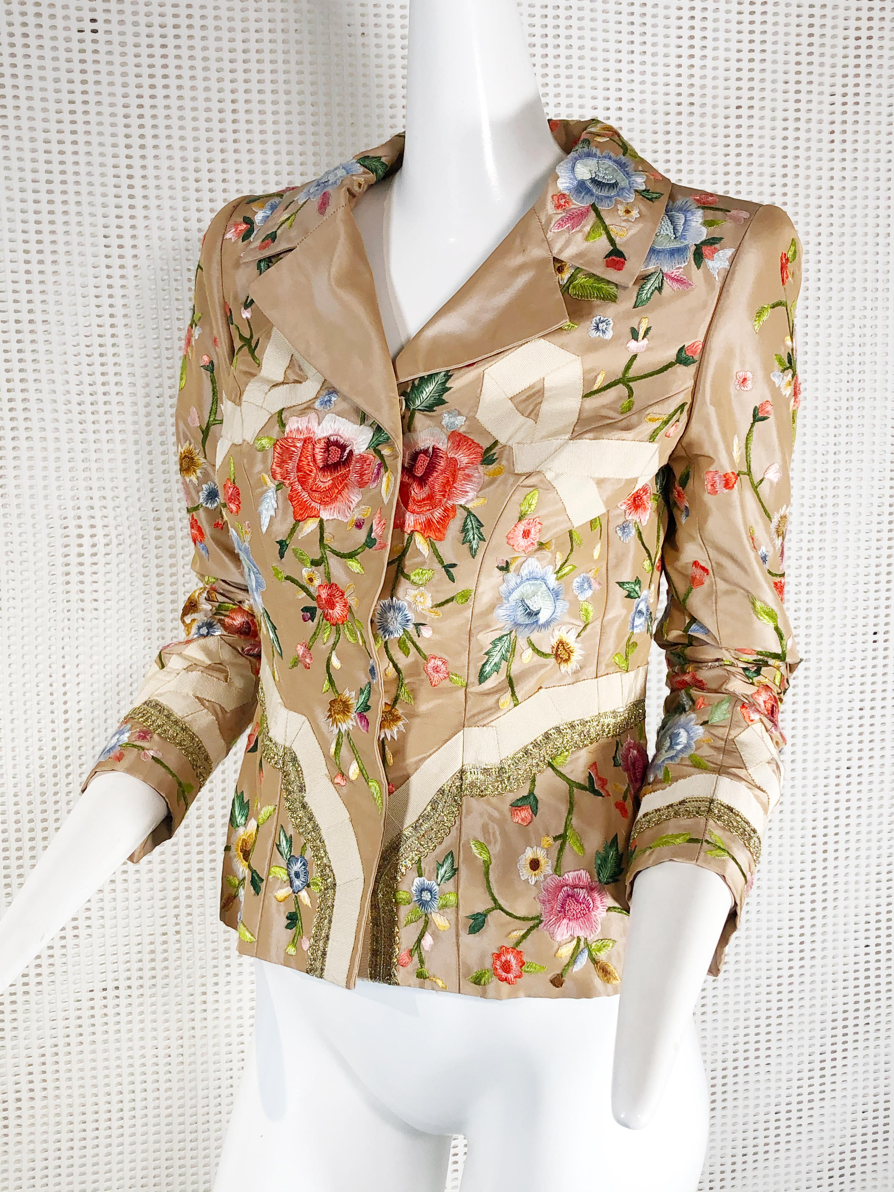 This feminine 2000 Oscar de la Renta jacket features gorgeous polychrome embroidered roses and petersham French bows with metallic braid at sleeves and hip. Front snap closure. Fits a modern size 4. 