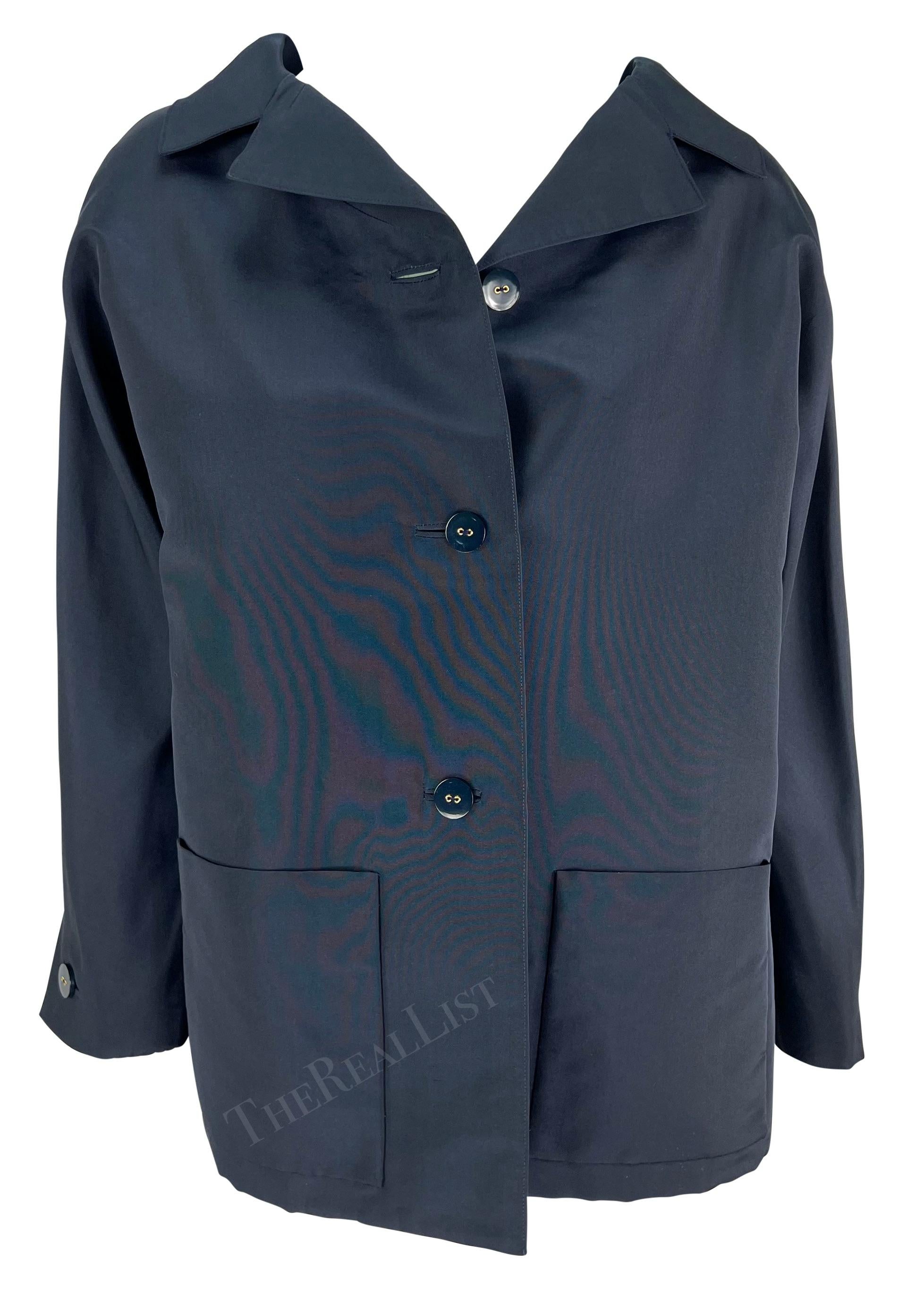 Presenting a fabulous navy blue Pierre Balmain haute couture car coat, designed by Oscar de la Renta. From 2000, this custom handmade coat features a fold-over collar, button-down closure, and pockets at the hips. This oversized car coat is expertly