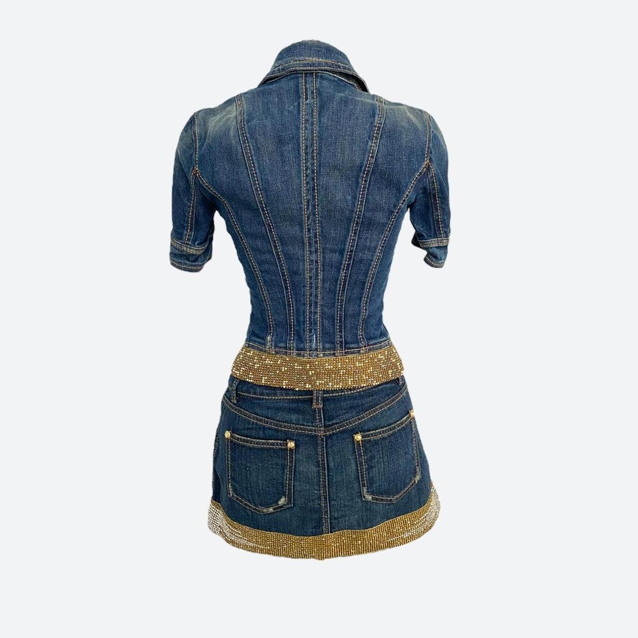 Mini skirt and short-sleeve jacket two-piece set in cotton denim with gold, rhinestone and bead embellishments on the hems of both pieces. The sparkling details on the hems provide an elevated, glamorous style to the edgy essence of denim. 

The