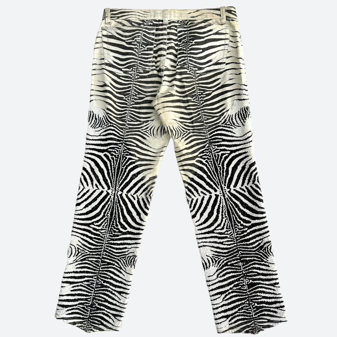 From the Roberto Cavalli SS Diamond Collection, these rare high-quality zebra-
print pants are completely embellished from the thighs down in intricate, hand-
embroidered beading details, enhancing the pattern of the print and adding an

exquisite