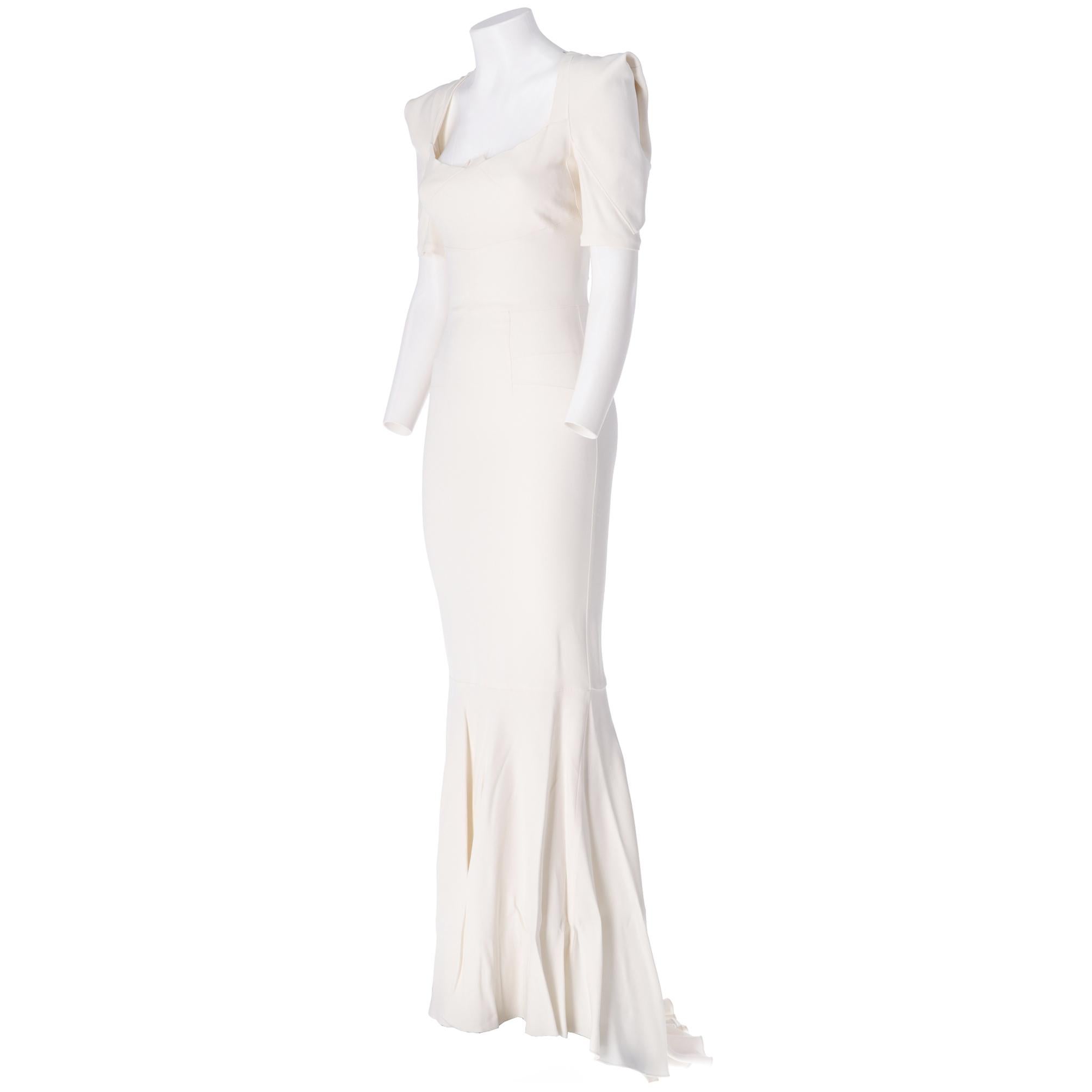 Roland Mouret ivory mermaid wedding dress with train, cut at the waist, long mermaid skirt, square neckline, half sleeves with fantasy design construction, zip closure on the back.

The item has a small stain near the zip on the back and slight