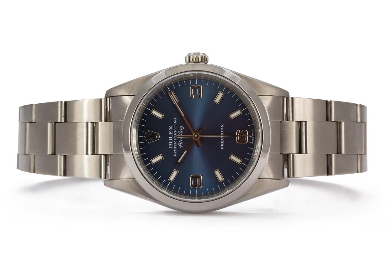 We are pleased to offer this 2000 Rolex Stainless Steel Oyster Perpetual Airking 14000M. It features a 34mm stainless steel case with stunning blue dial, luminous index and arabic hour markers and stainless steel oyster bracelet. It will fit up to a