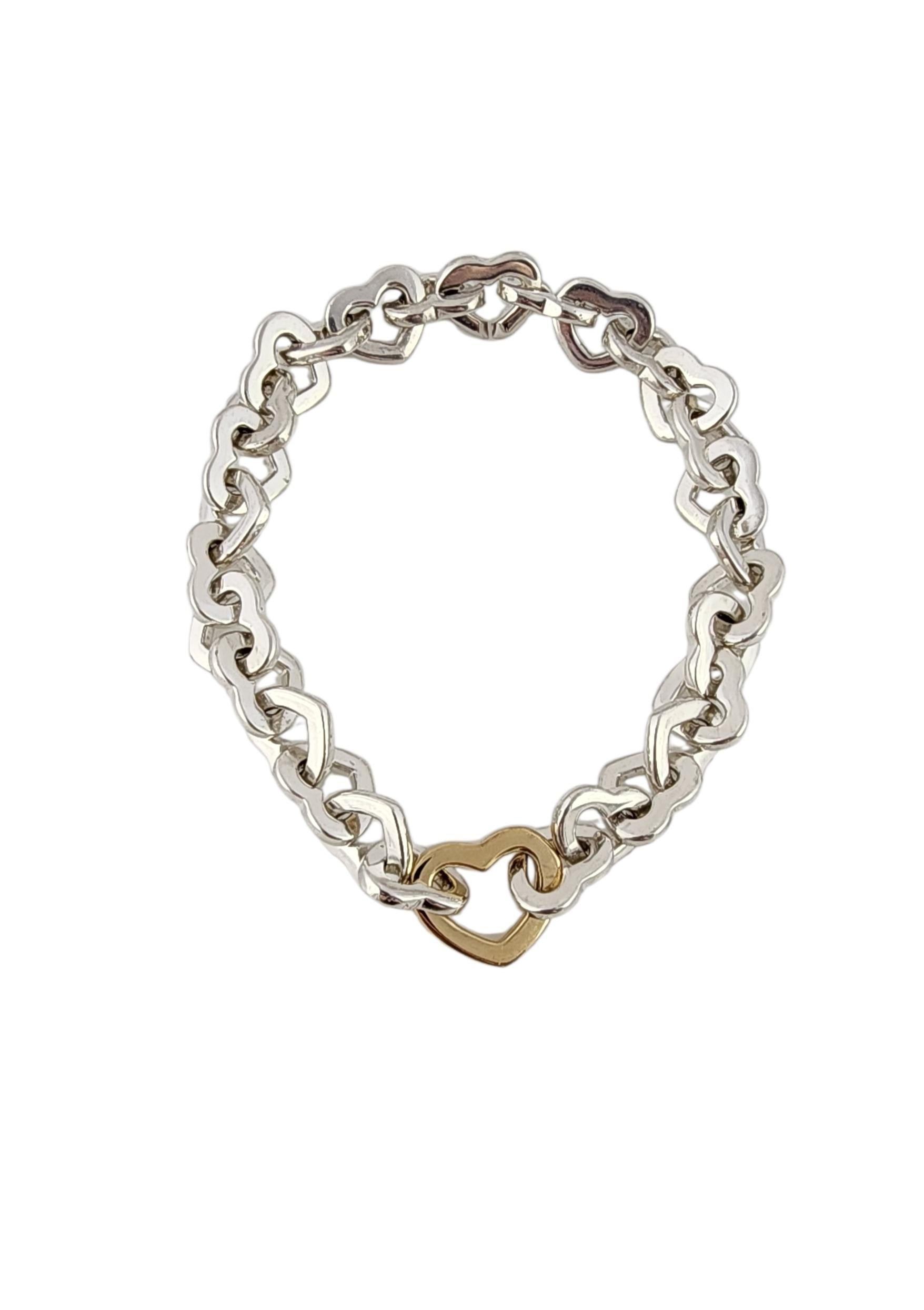 2000 Tiffany 
Co. Sterling Silver and 18K Yellow Gold Heart Bracelet

Celebrate timeless elegance with this 2000 Tiffany and Company Heart Bracelet. It features beautifully polished sterling silver heart links that meet in the middle with a