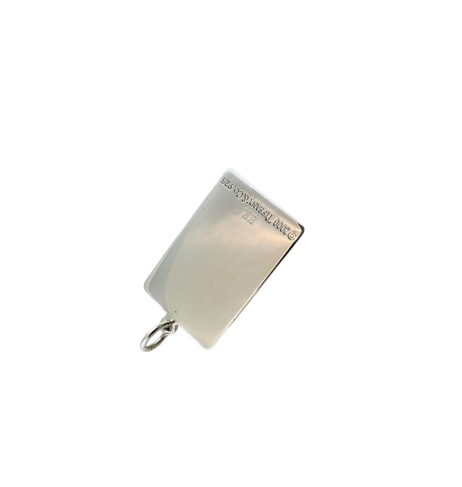 2000 Tiffany & Co. Sterling Silver Welcome Mat Pendant w/Pouch 

This rectangular pendant by Tiffany & Co is in the design of a welcome doormat. It can be used as a key ring as well if ring was added to pendant. 

Approx. 1 1/4