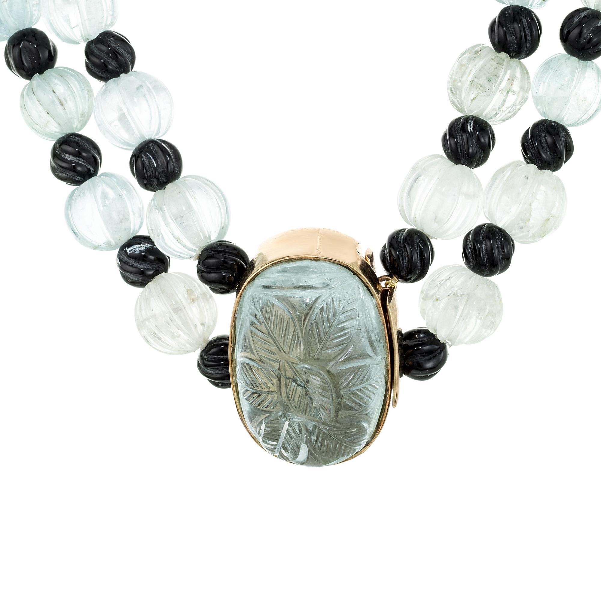 English hand carved 1920's Art Deco genuine natural untreated Aqua and Onyx two strand necklace. 16.5 to 17 inch length. Genuine carved Aqua beads 10mm to 8mm. alternating with round onyx beads. The catch has an oval aquamarine which is carved as