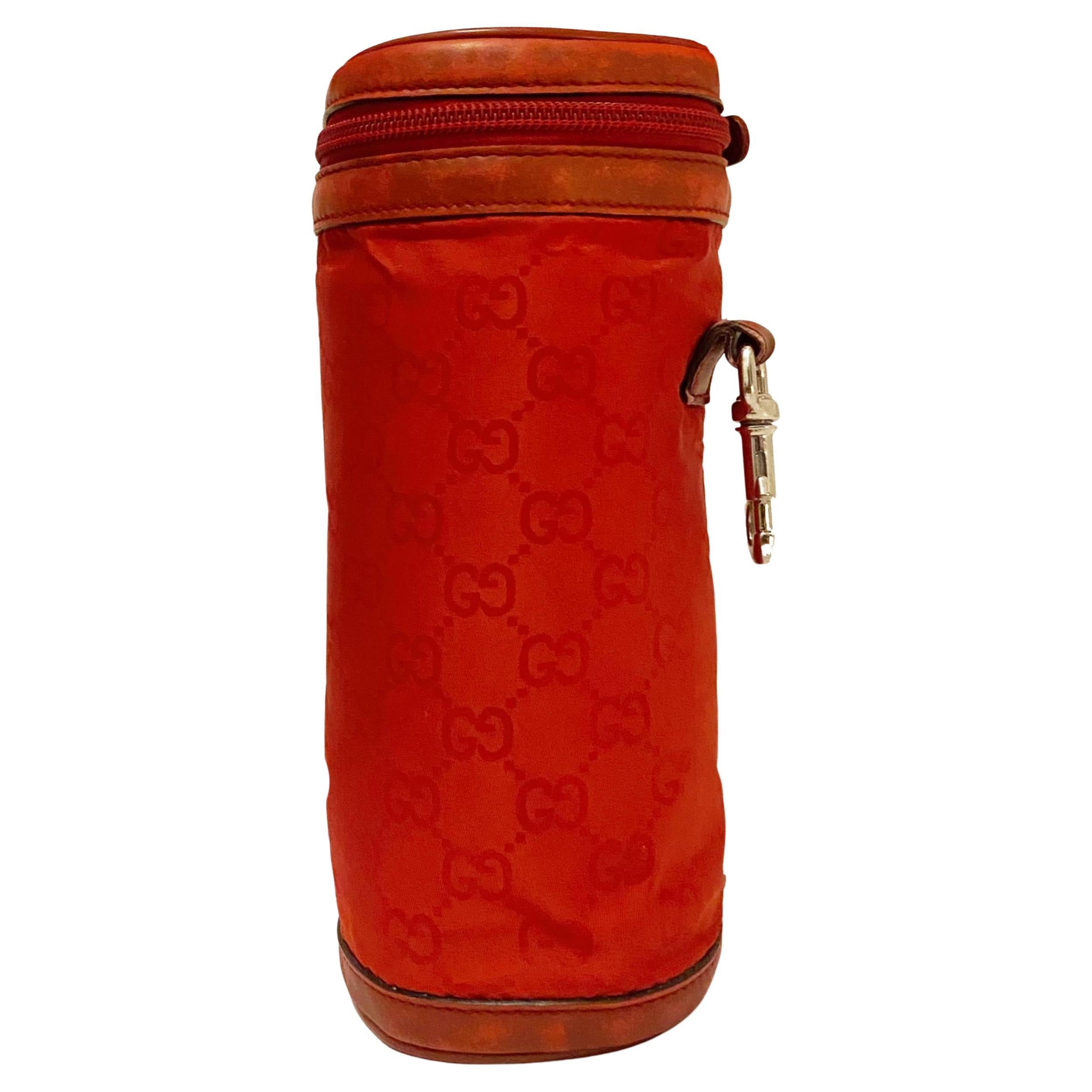 This exquisite Gucci Bottle Holder has been crafted with sophisticated elegance and luxury in mind. Intended to securely carry a bottle, but with the versatility to also serve as a petite purse, its handsome monogrammed exterior in classic red is