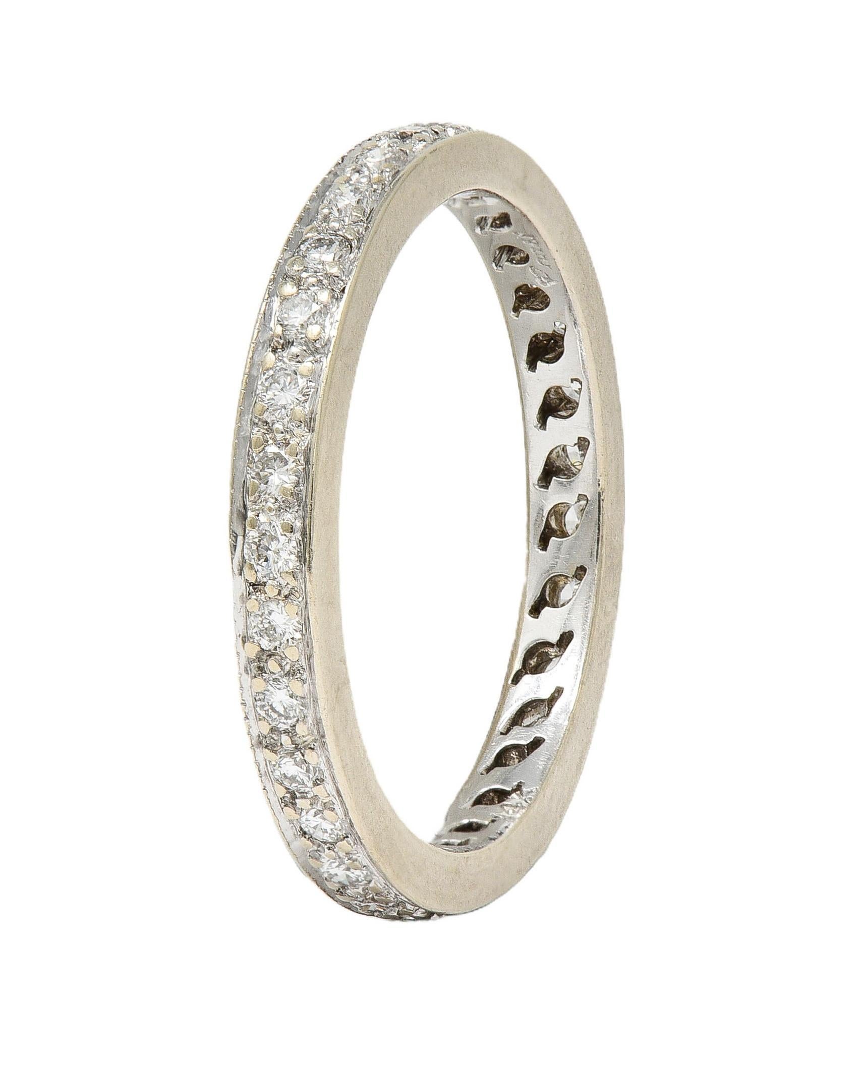 Featuring round brilliant cut diamonds fully around 
Weighing approximately 0.45 carat total 
G/H color with VS2 clarity
Bead set in raised channel
Stamped for 14 karat gold
With partial maker's mark
Circa: 2000s
Ring Size: 5 and not