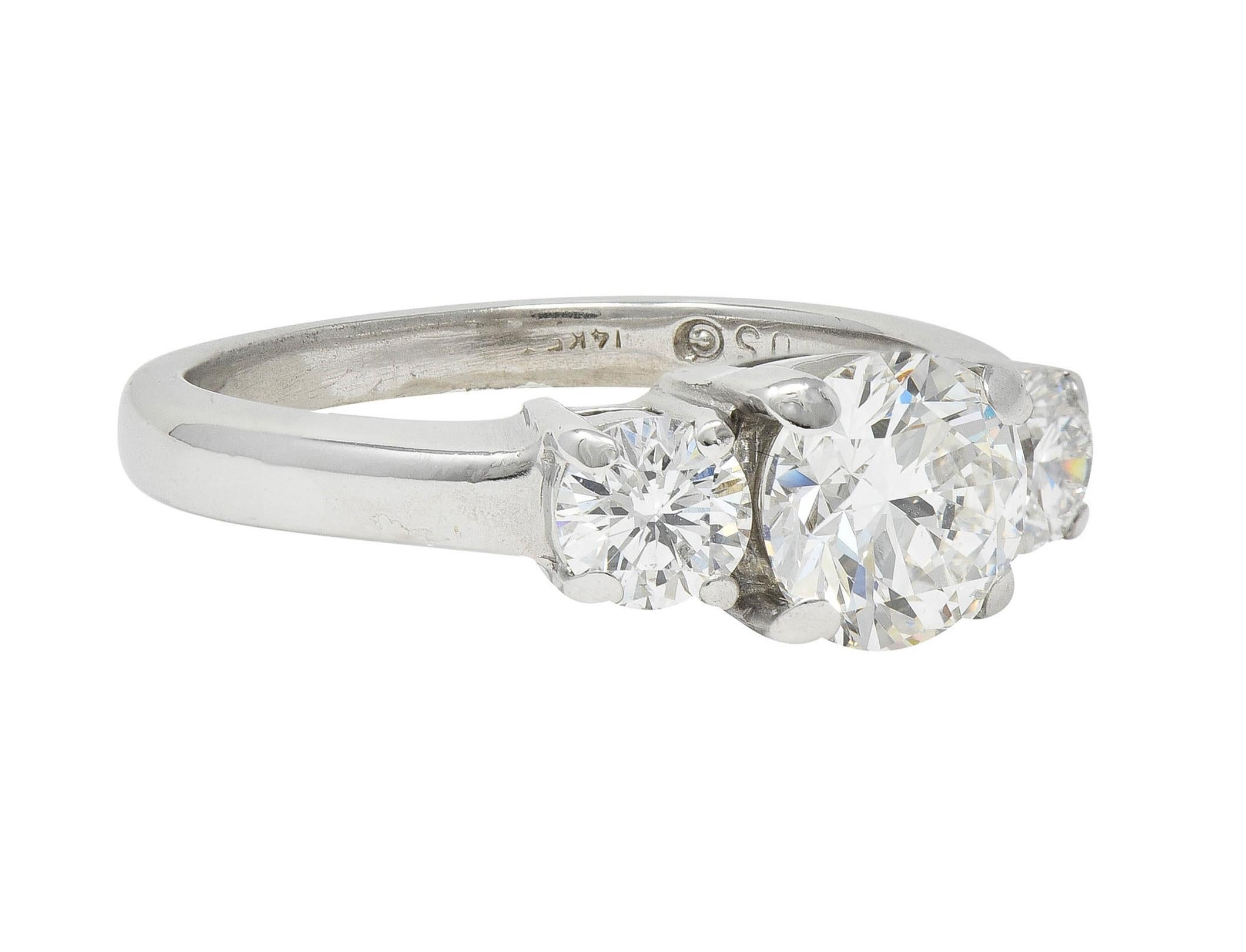 Centering a transitional cut diamond weighing 1.52 carats - G color with SI2 clarity
Flanked by round brilliant cut diamonds - each prong set in basket
Weighing approximately 0.78 carat total - G color with SI2 clarity
Completed by high polish