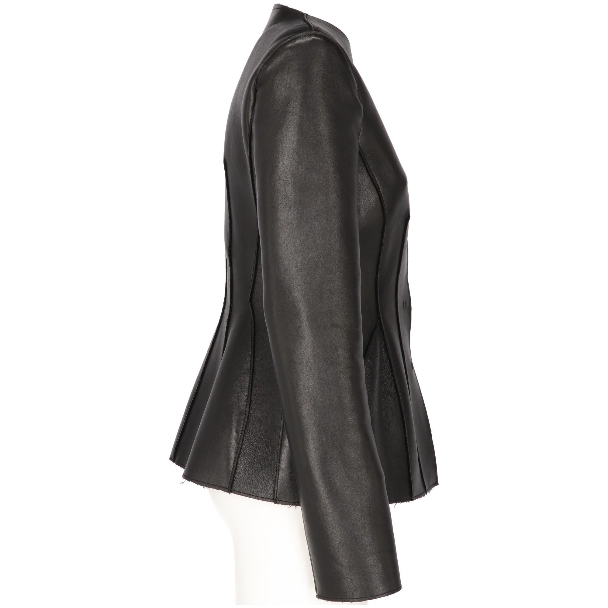 The stylish Alberta Ferretti black leather waist fit jacket features a large round neckline, with front buttoned fastening and decorative visible stitchings and raw edges.
Years: 2000s

Made in Italy 

Size: 42 IT

Linear measures

Height: 64