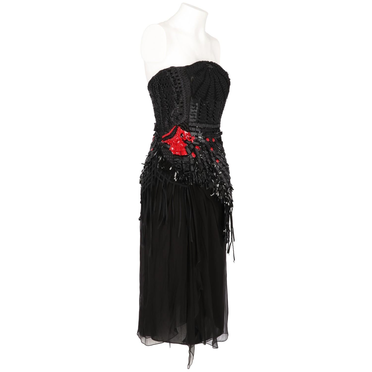 The elegant Alberta Ferretti black layered silk short dress features braided ribbons inserts and red and black decorative sequins and beads embroidered details. With a side zip fastening and an inner bust.

Years: 2000s
Made in Italy
Size: 40