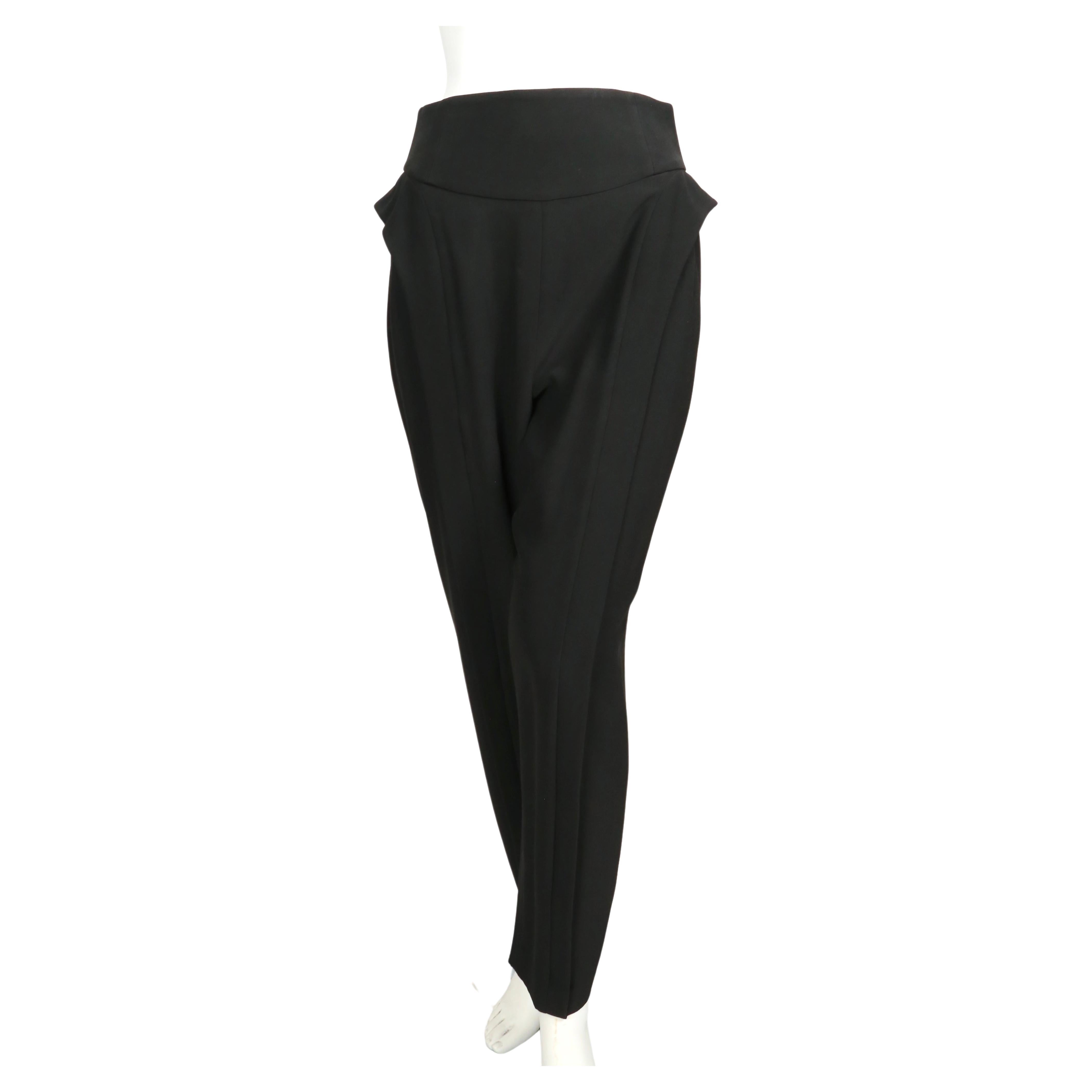 Black high waist pants with side ruffles designed by Alexander McQueen dating to the 2000's. Labeled an Italian size 42. Pants were not clipped on French size 36 mannequin. Approximate measurements: waist 27