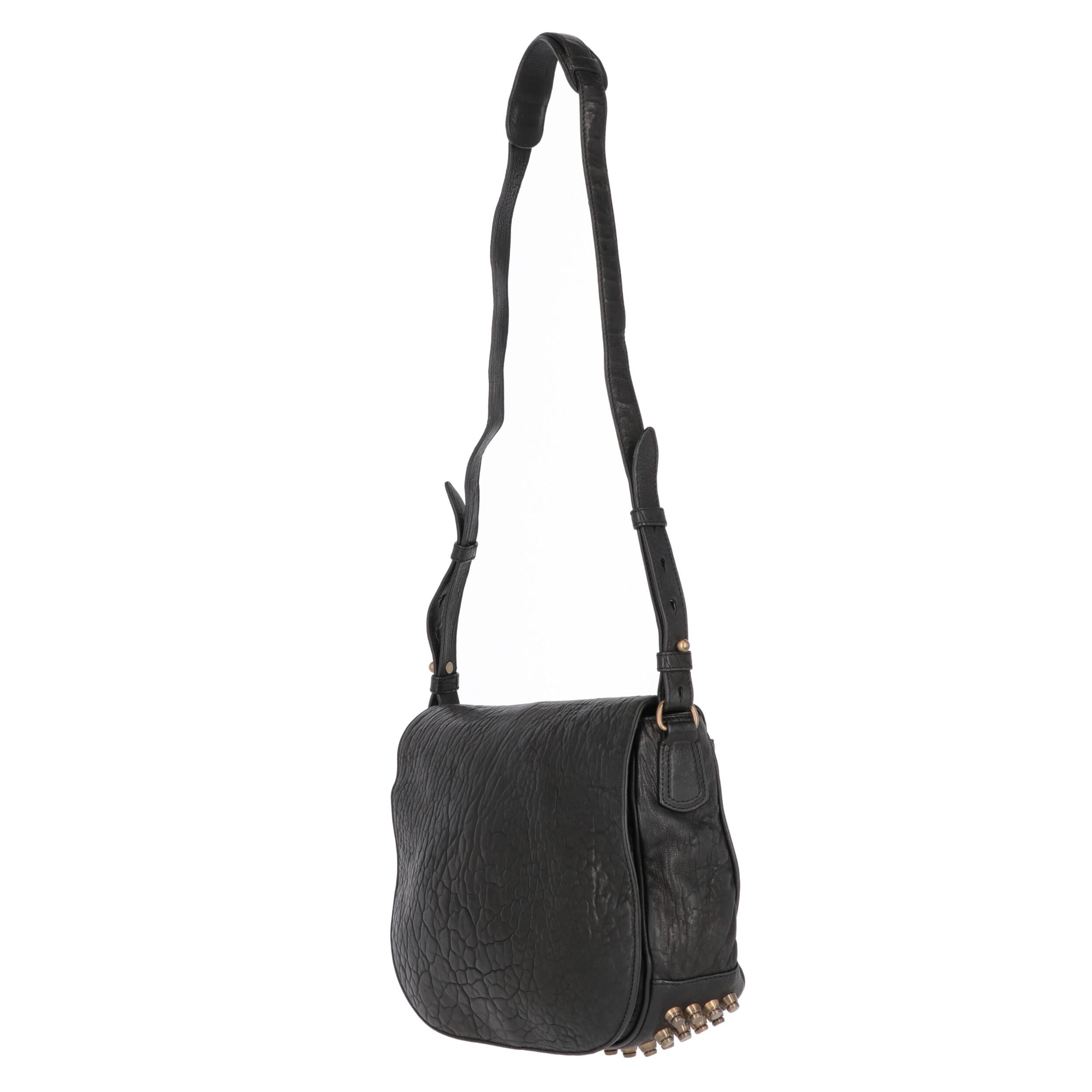 Alexander Wang black textured leather shoulder bag. Half-moon shape, flap and hidden magnetic stud, open rear pocket and adjustable shoulder strap. Full of metal studs on the base.

Years: 2000s
Made in China

Flat measurements

Height: 26 cm
Width:
