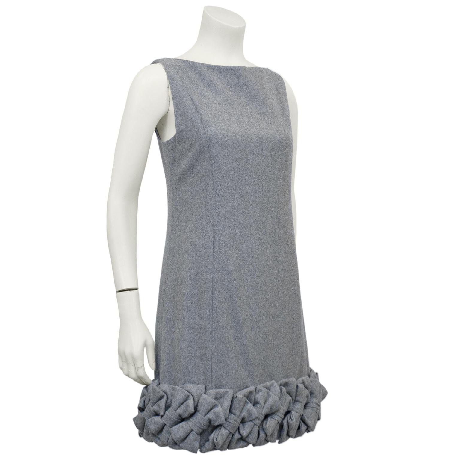 Early 2000's Alexis Mabille demi couture grey wool dress. Sleeveless with a high boat neckline. Slight a-line shape. Hem is embellished with large grey wool bow details sewn together on a diagonal. Invisible zipper closure up centre back. Grey