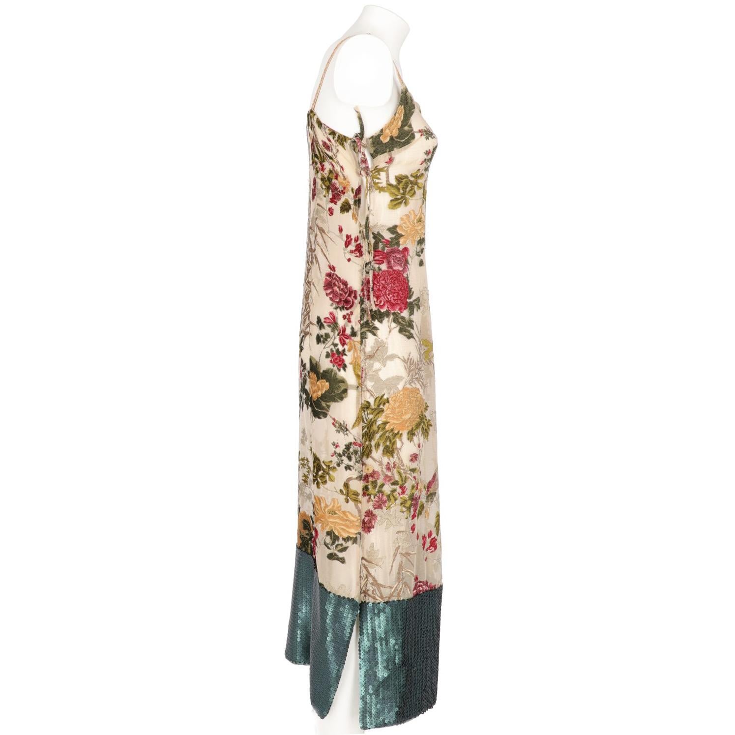 The lovely Antonio Marras beige and gold silk brocade long dress features  a colored flore & fauna chenille inserts and an elegant dark green sequin insert on the edges, with beige shoulder straps with flowers embroideries and adjustable strings on