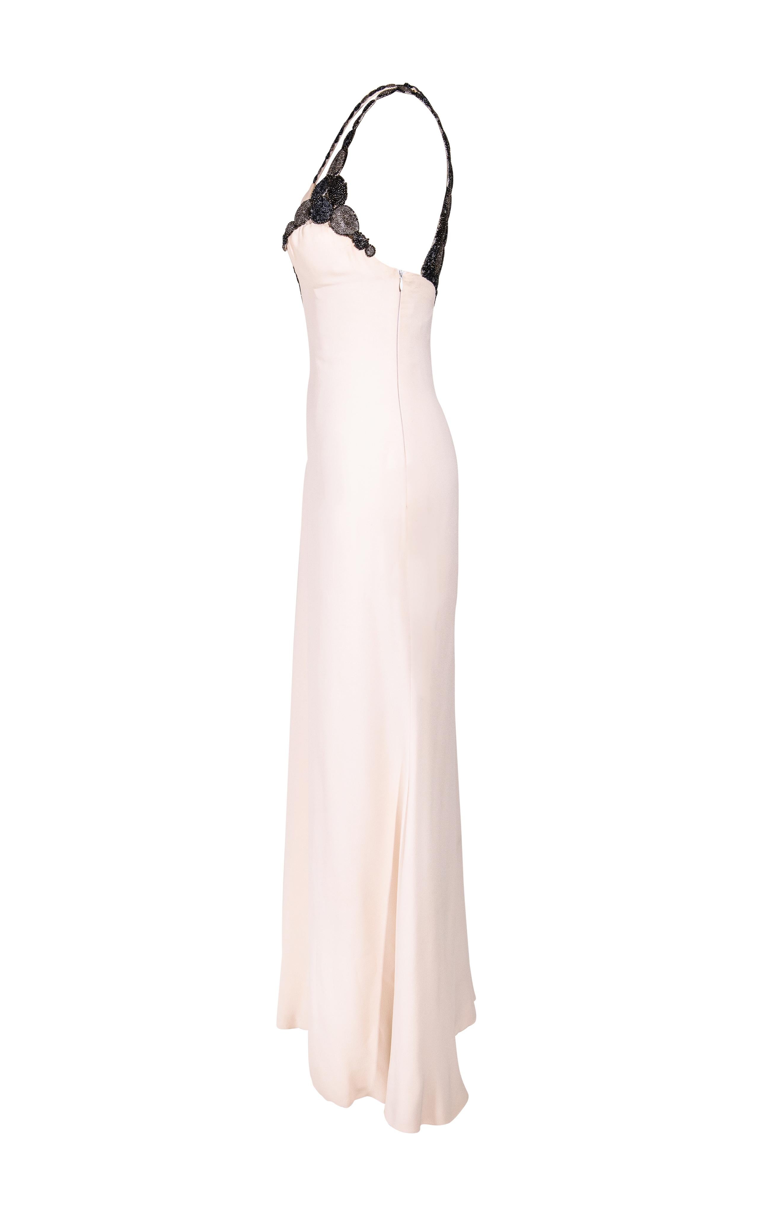 2000's Atelier Versace Haute Couture one-of-one silk embellished cream gown. Cream gown with gunmetal circular beaded design cutout straps and hidden side zip closure. Features built-in boning on right side to create a slight corset effect. Fabric
