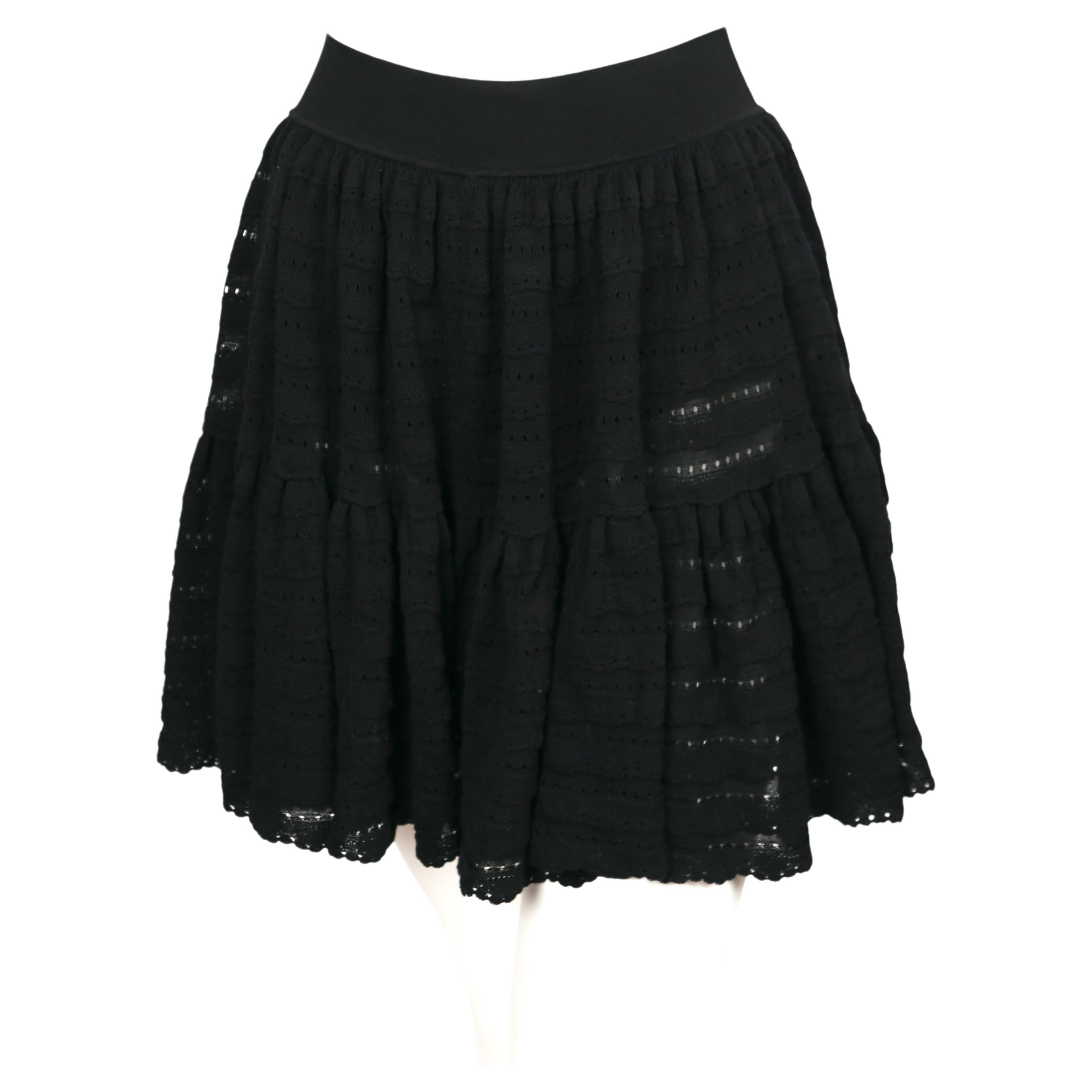 Black mini skirt with ruffled, open-work pointelle knit tiers and hidden shorts from Azzedine Alaia dating to the 2000's. Labeled a size 'XS'. Approximate measurements: waist 23