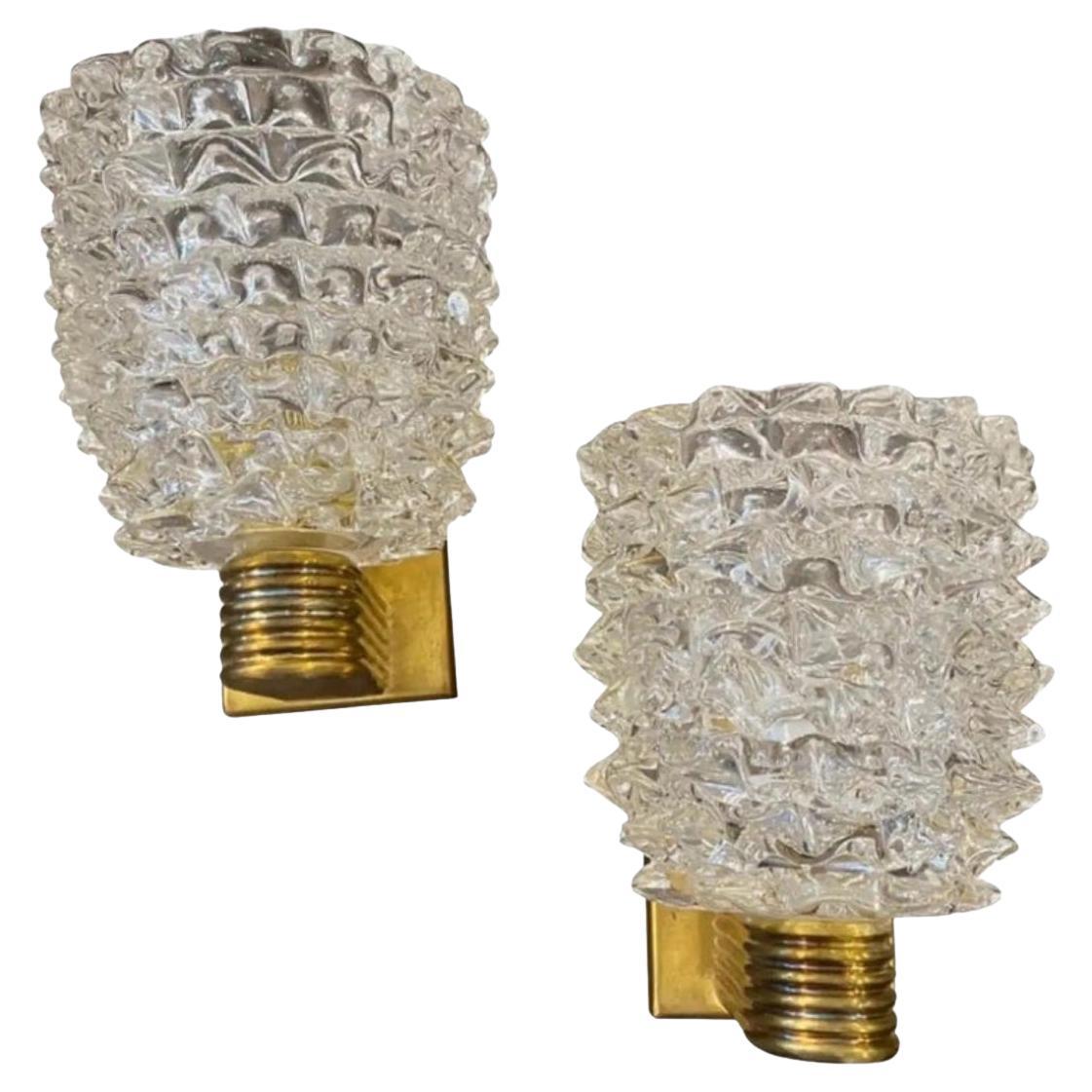 A pair of wall lights designed and manufactured in Italy in the style of Barovier, which invented this particular glass processing technique named Rostrato characterized by large light-reflecting points. These points are obtained through a